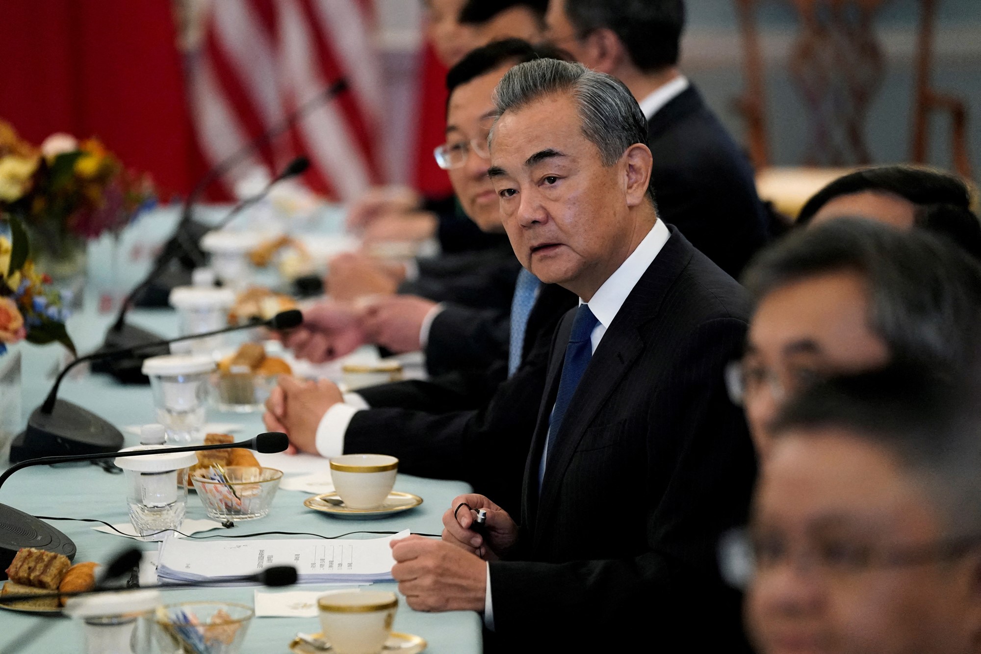 Man sits at a dinner table looking concerned 