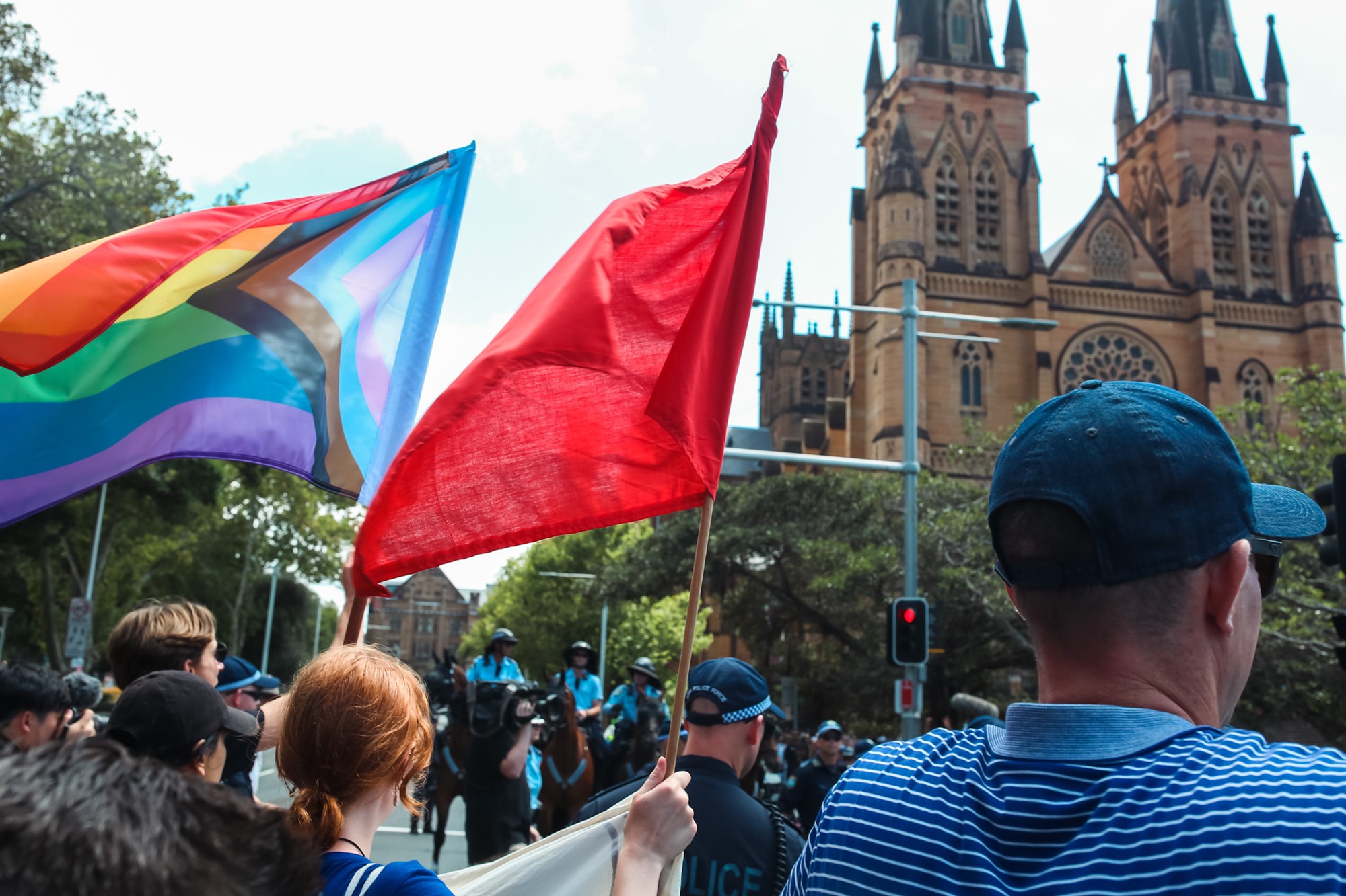 Marchers hold rainbow flags