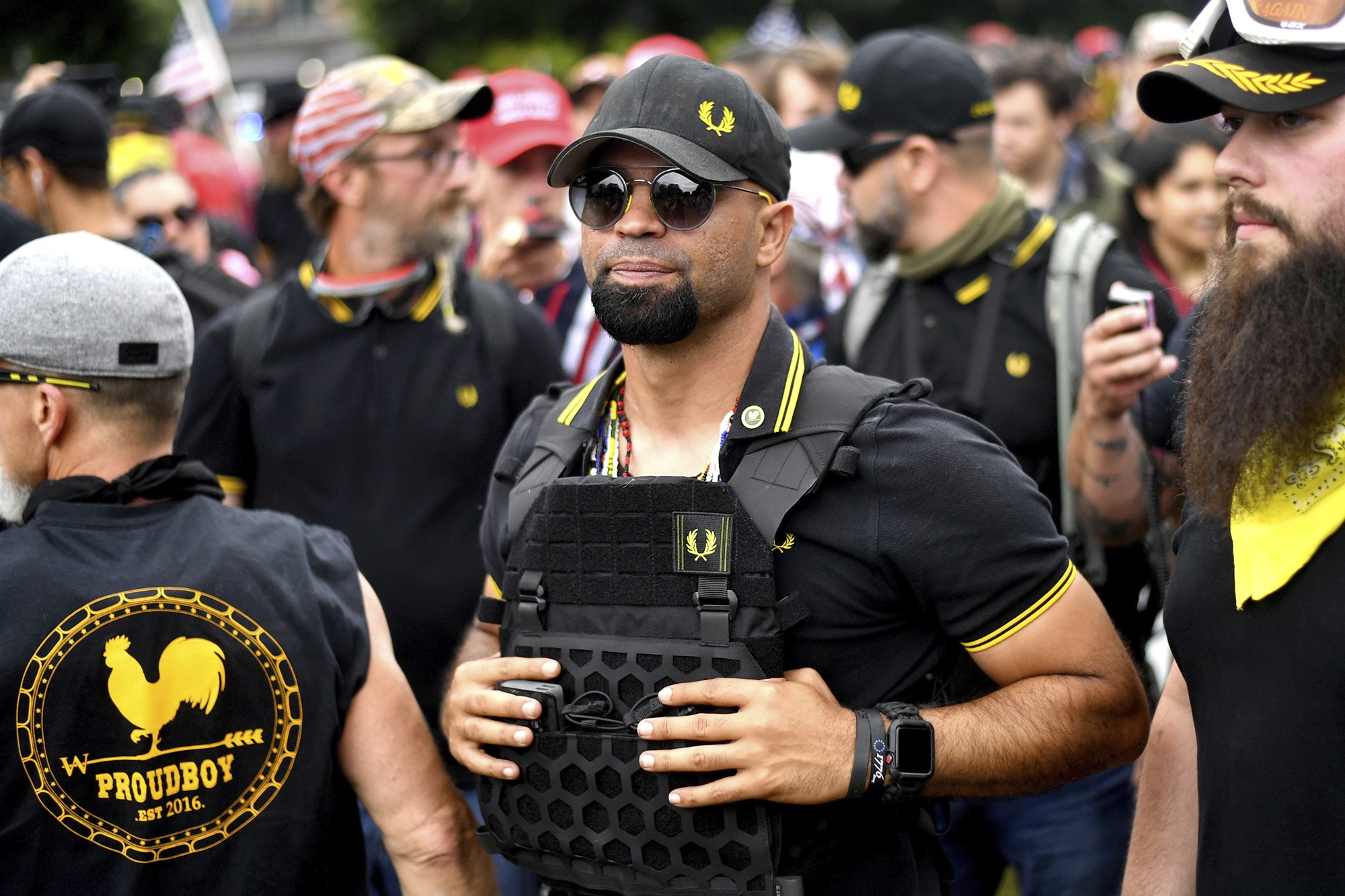 Enrique stands with other Proud Boys dressed in black and yellow.