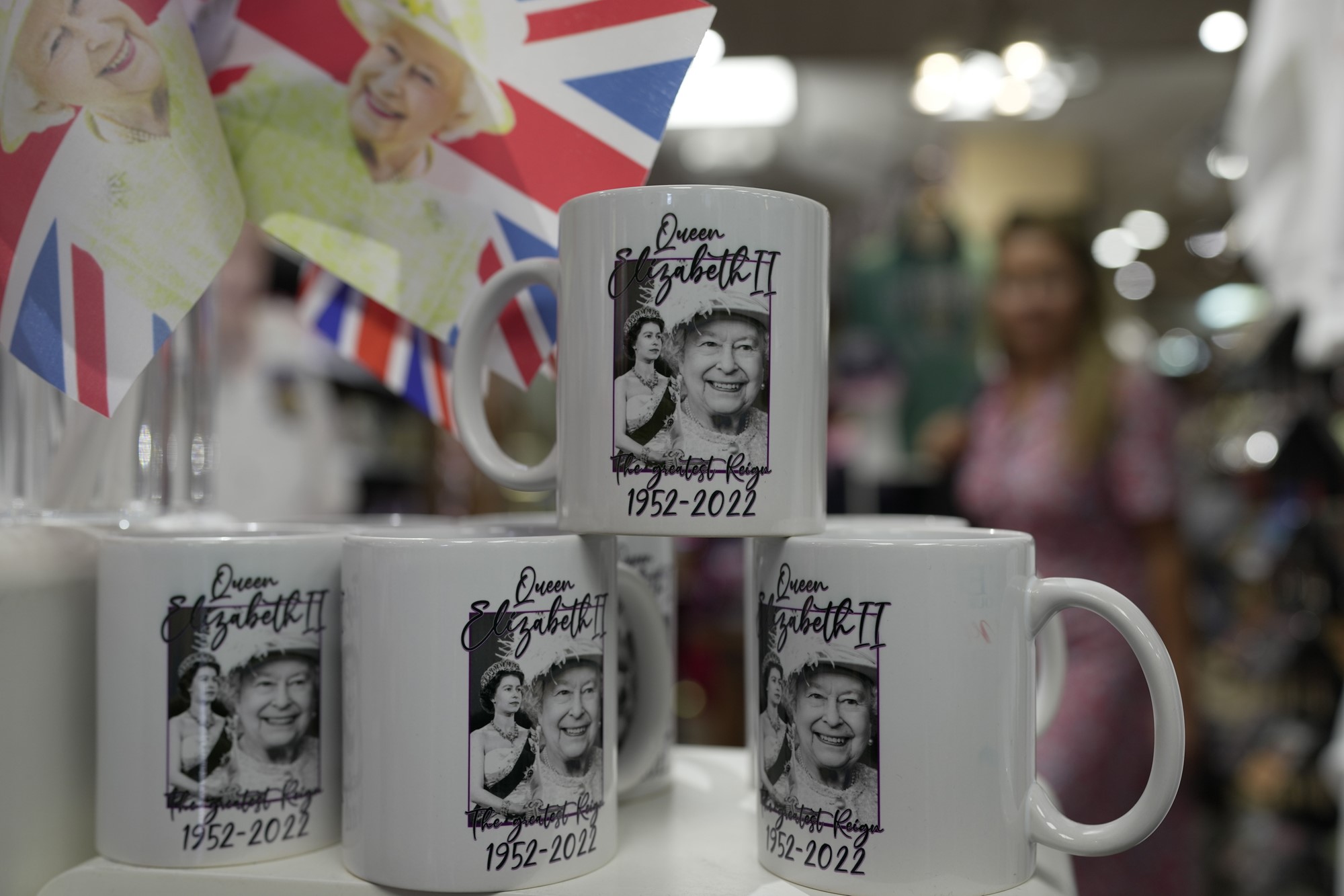 Mugs with print of Queen Elizabeth II are displayed for sale at a gift shop in London, Monday, Sept. 12, 2022