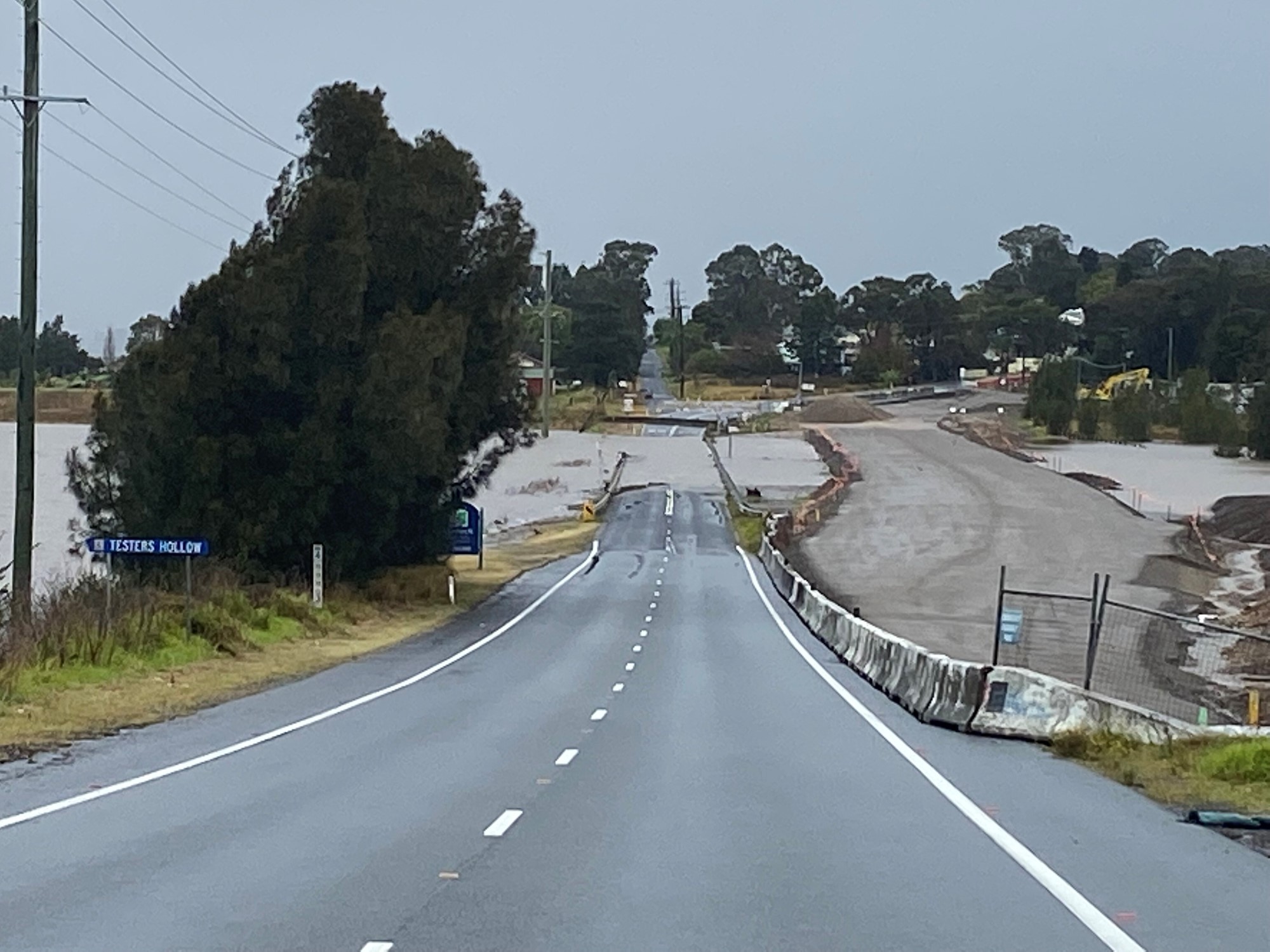 a wide image of a flooded road that has recently been raised to avoid flooding