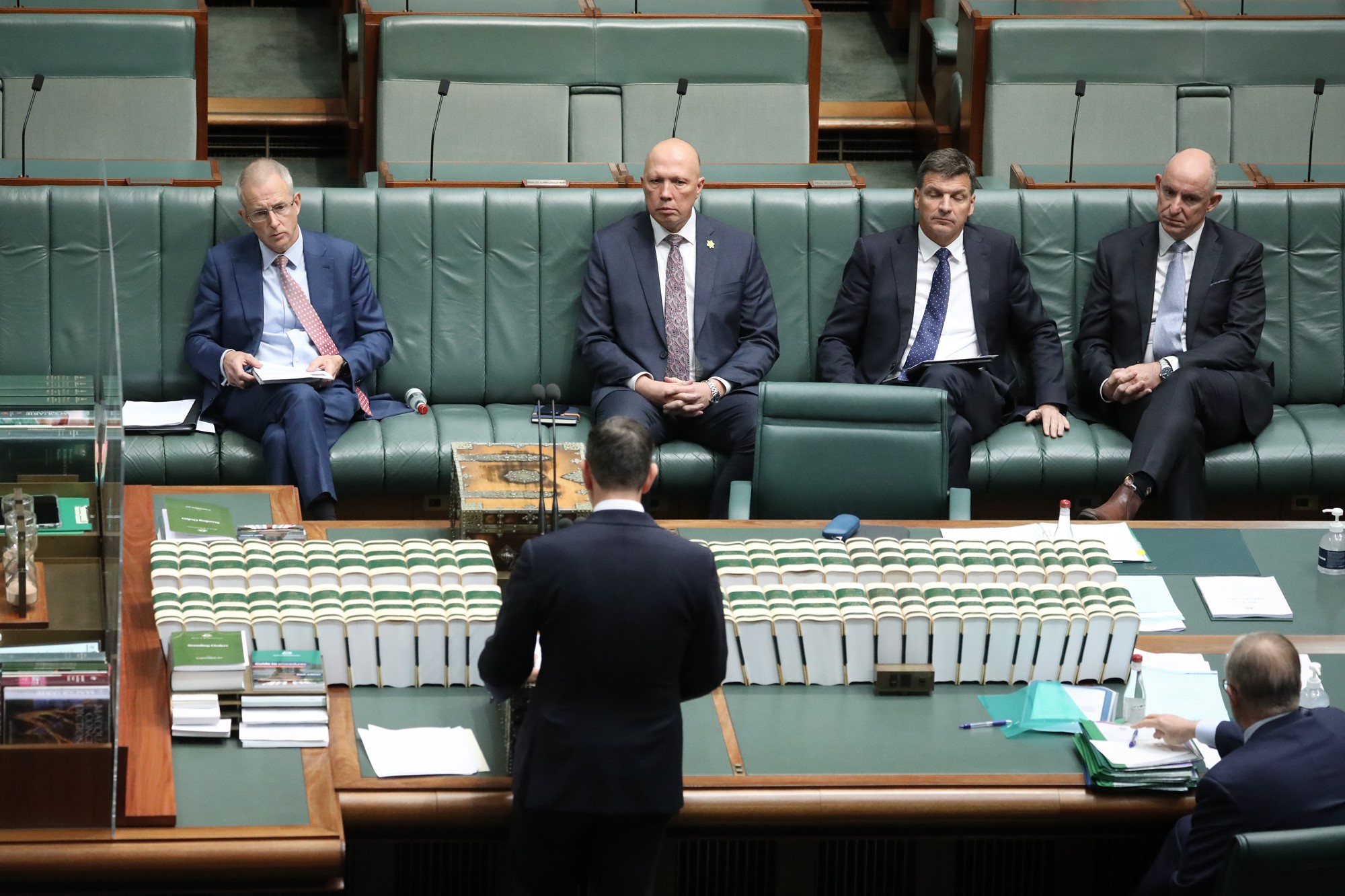 Opposition leader Peter Dutton listens.