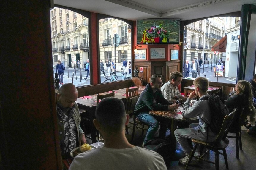 People sit around a table at a pub