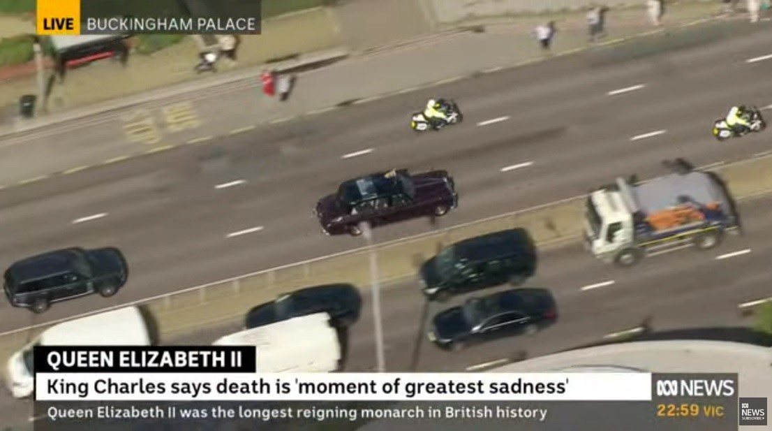 A motorcade is seen from a news camera.