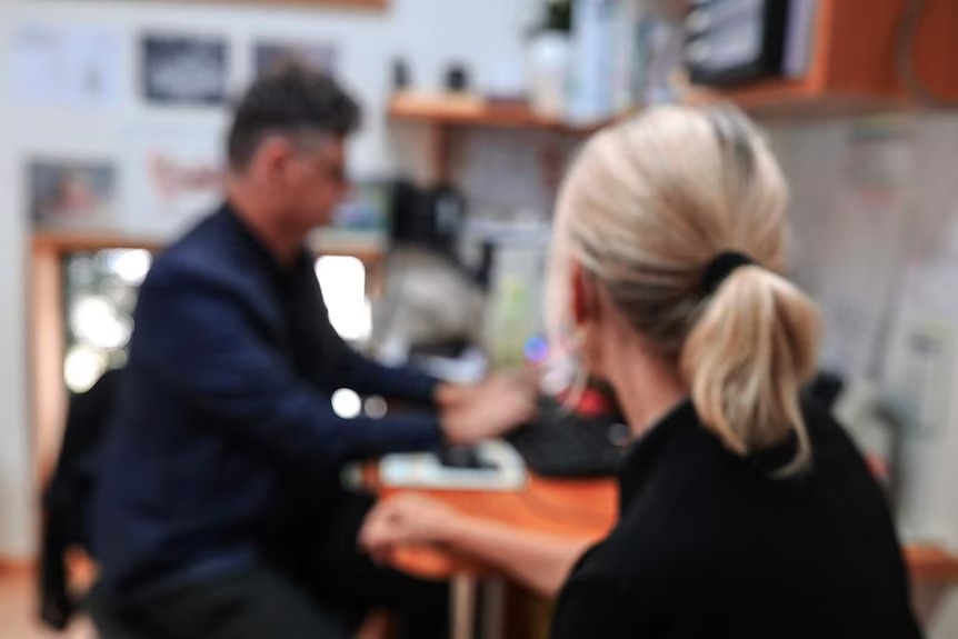 A woman is seen by a GP.