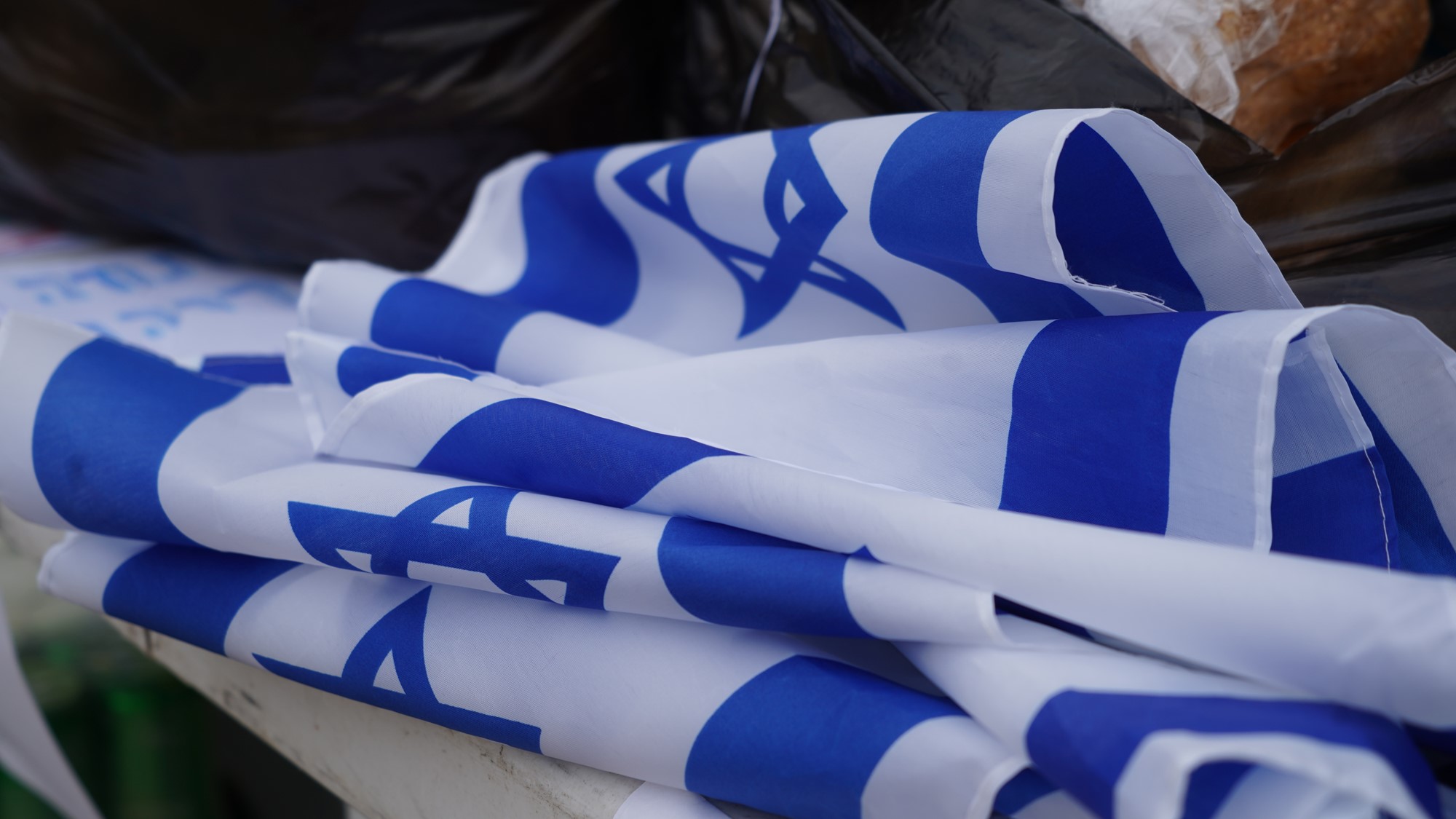 A pile of Israeli flags on a table