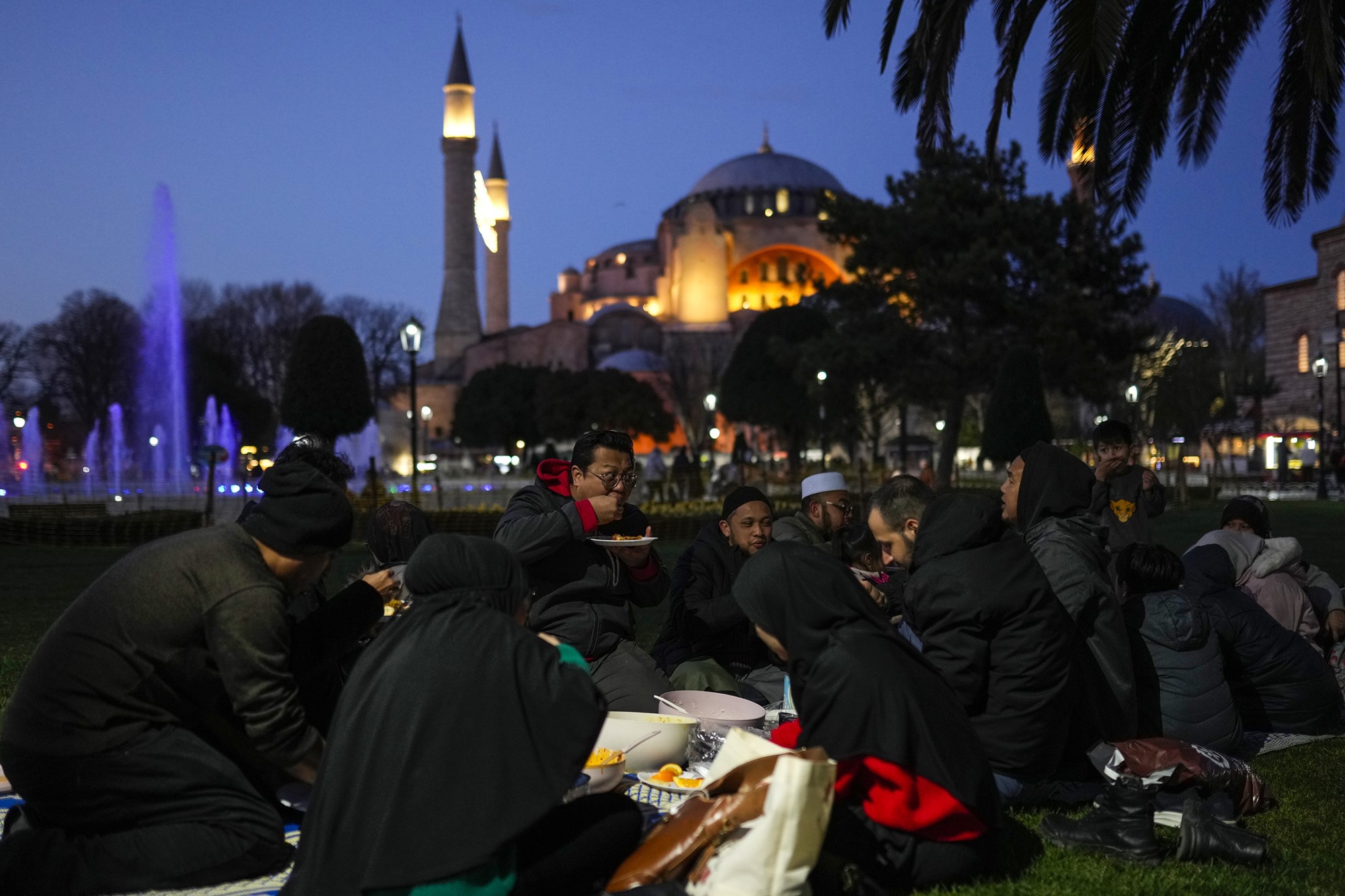 People are having a picnic at night. 