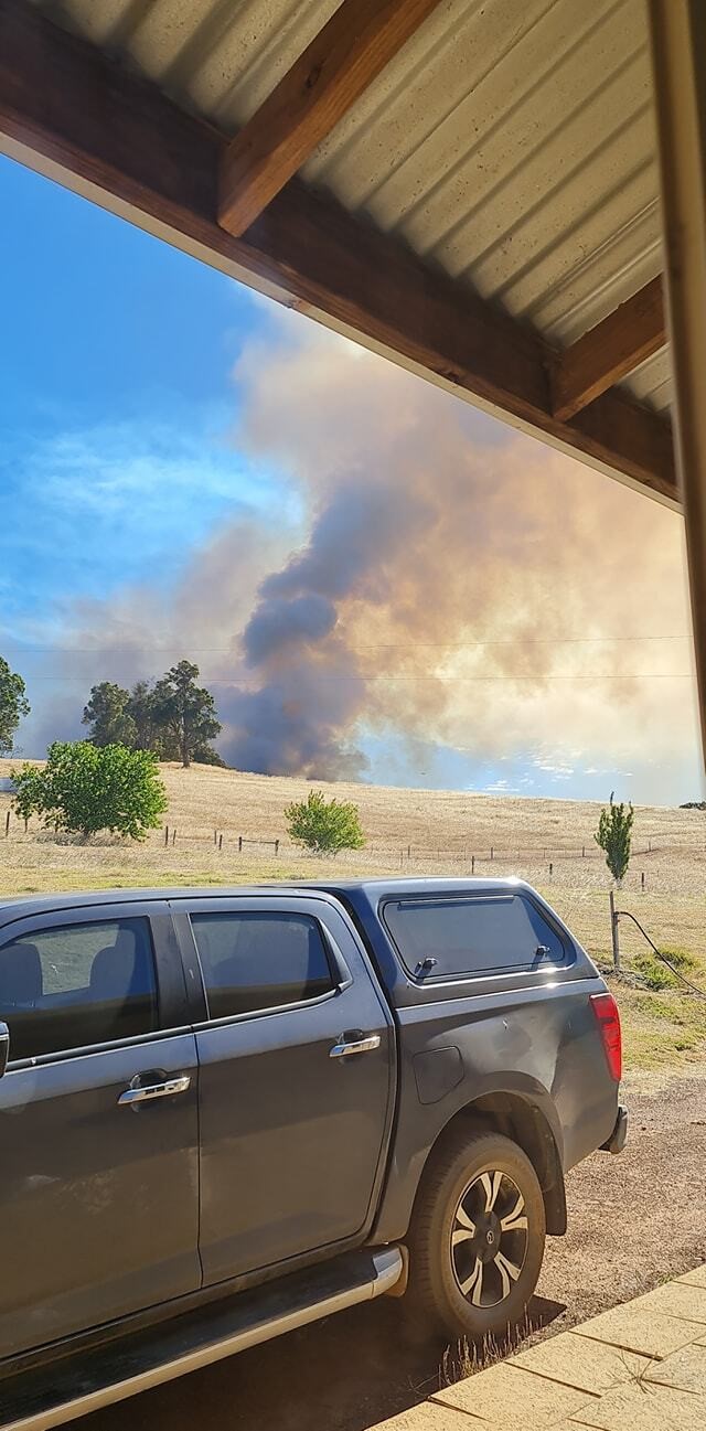 Smoke in the background of a rural proeprty.