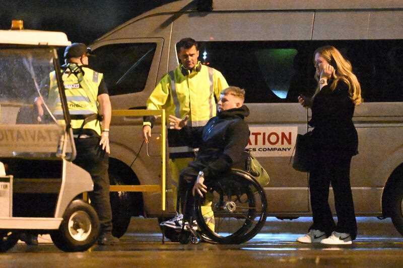 Dylan Alcott with two men and a woman in front of a van. 