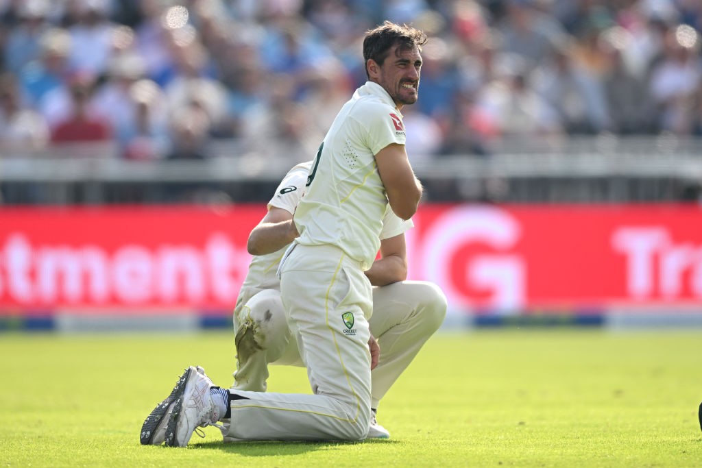 Australia fielder Mitchell Starc grimaces while on his knees during a Test.