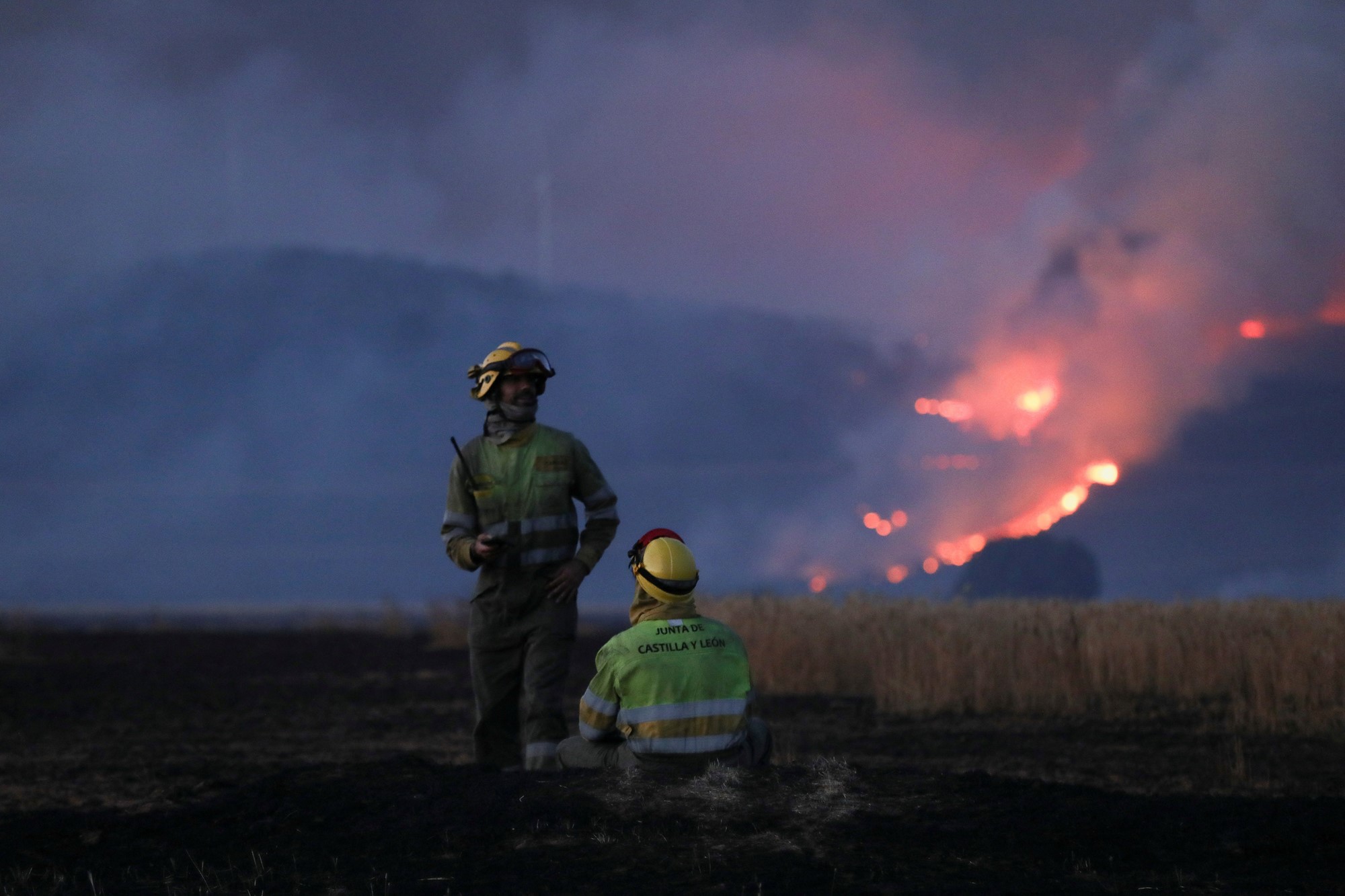 Firefighters work at the site of a wildfire outside Tabara, Zamora, on the second heatwave of the year, in Spain