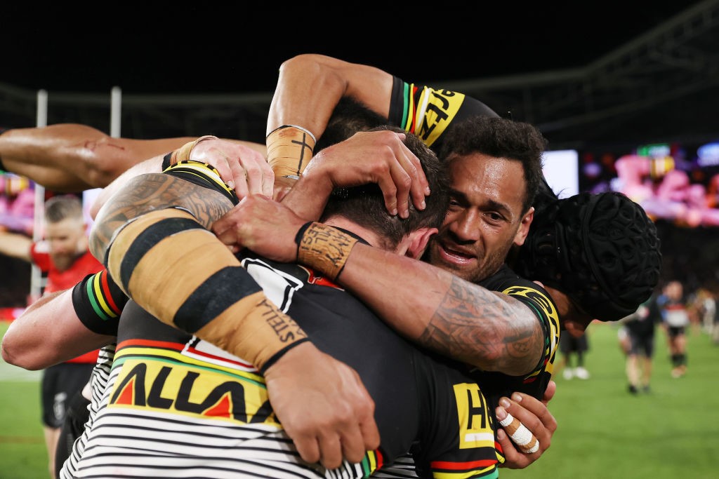 Penrith Panthers players embrace each other during the 2022 NRL grand final.