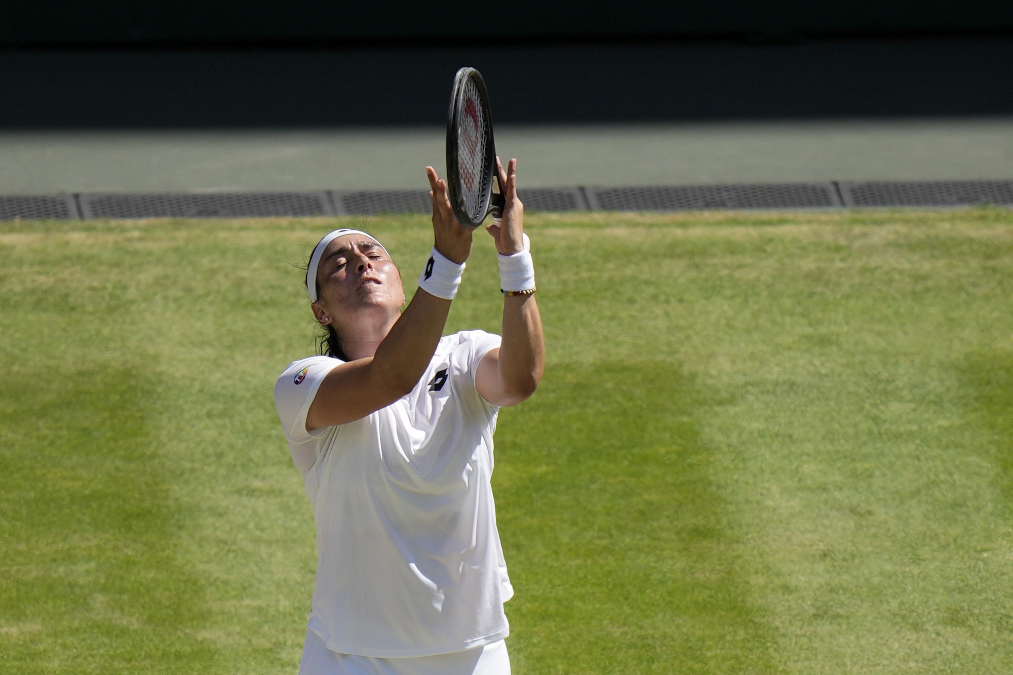 Ons Jabeur catches her racquet during the Wimbledon final.