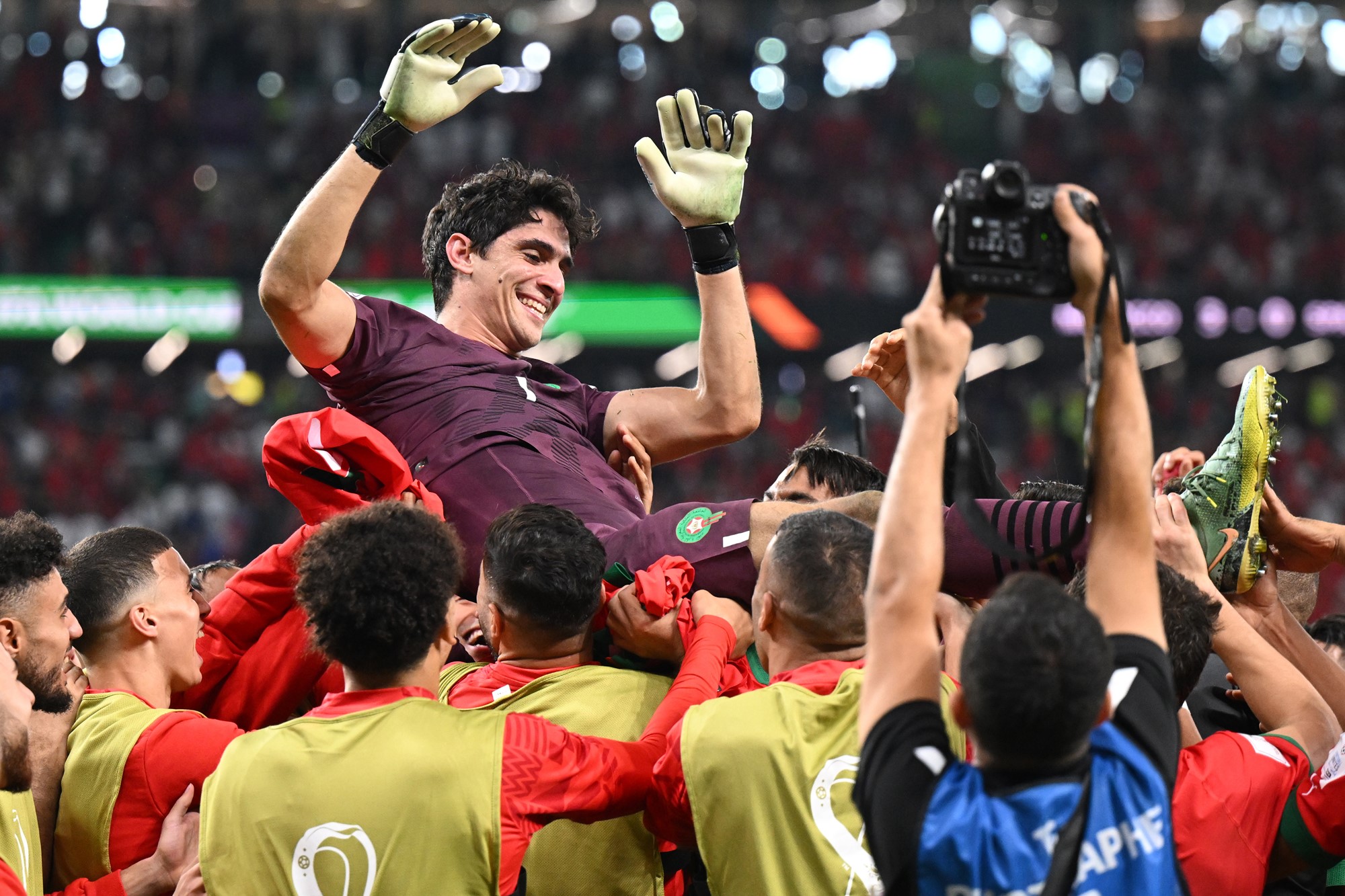 Morocco goalkeeper Yassine Bounouis carried triumphantly by teammates after they beat Spain at the FIFA World Cup.