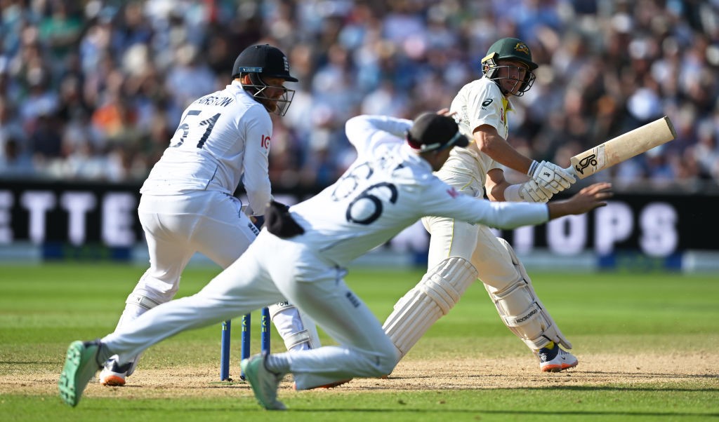 England's Joe Root dives to stop Marnus Labuschagne's reverse sweep.
