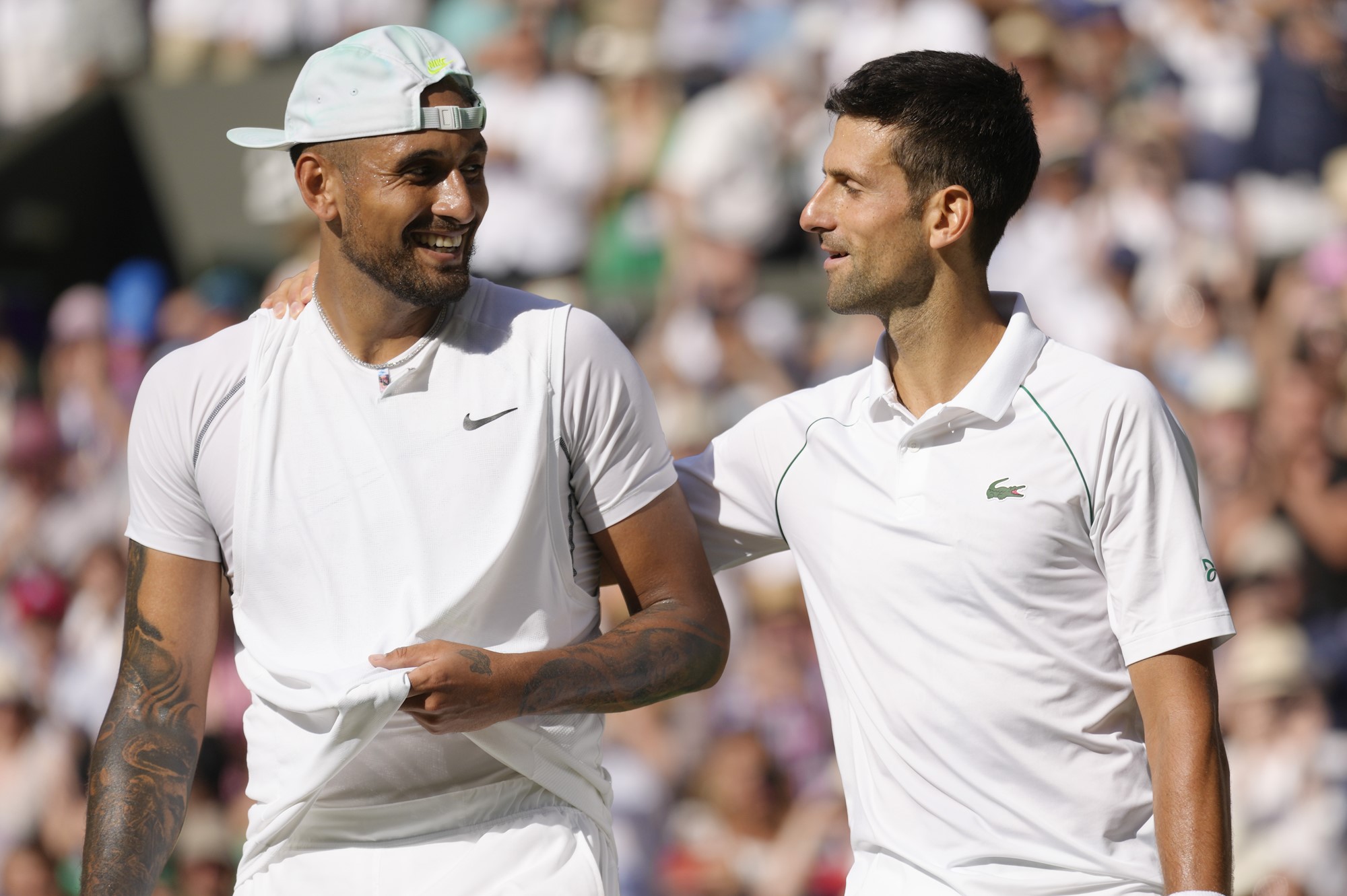 Novak Djokovic pats Nick Kyrgios on the back after their Wimbledon final.