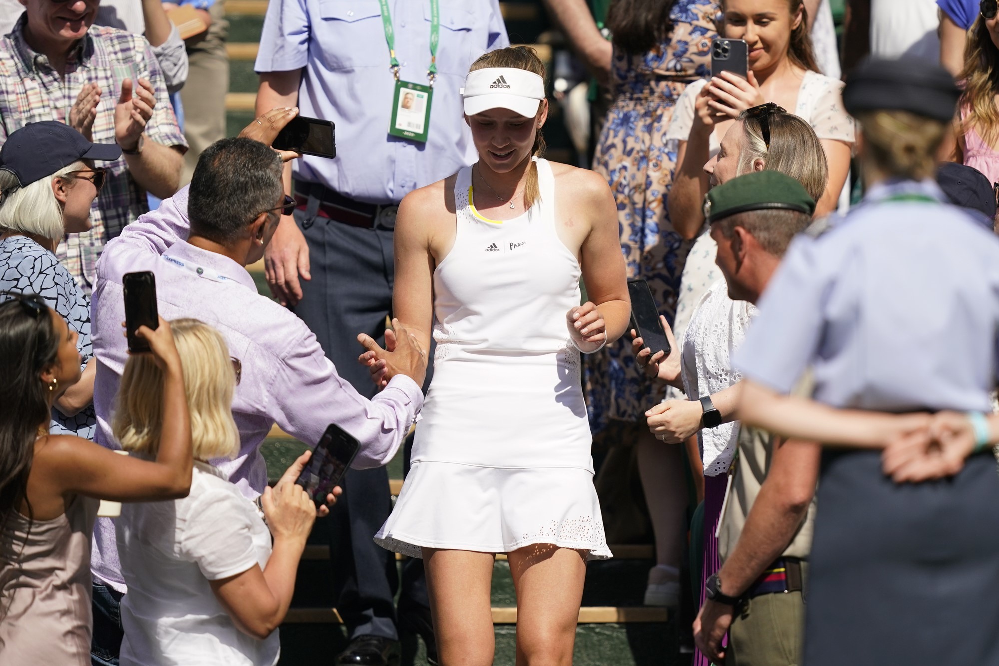 Elena Rybakina walks through the crowd after winning the Wimbledon final.