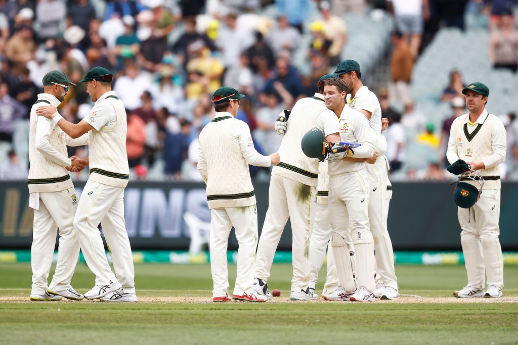Australian cricketers hug on the field after winning the Boxing Day Test against South Africa.