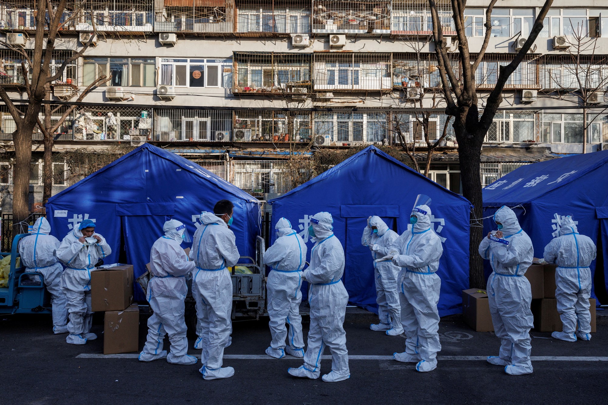 Pandemic prevention workers gather before their shift to look after buildings where residents do home quarantine