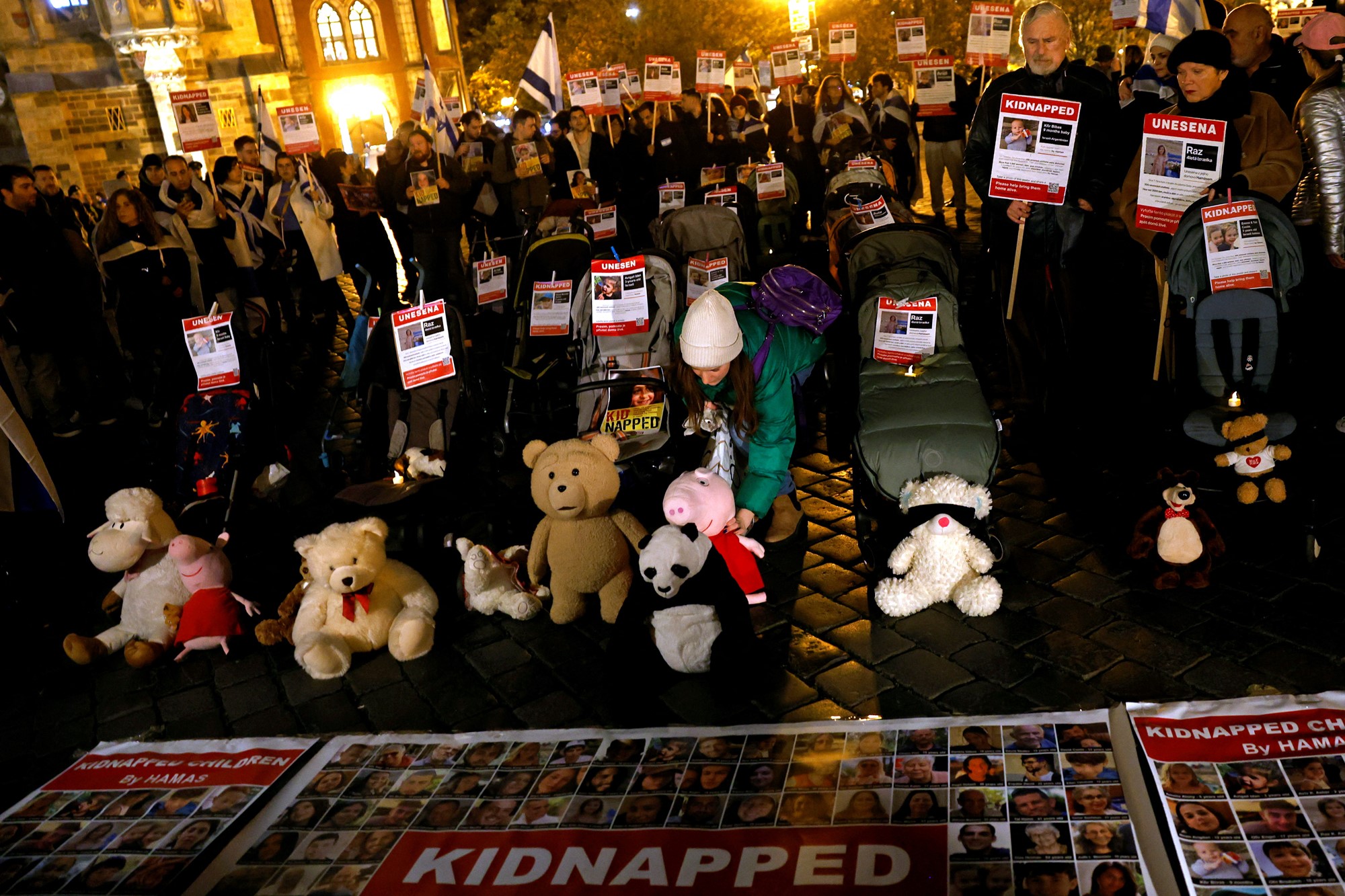 a group of women chant and hold signs in the dark and cold
