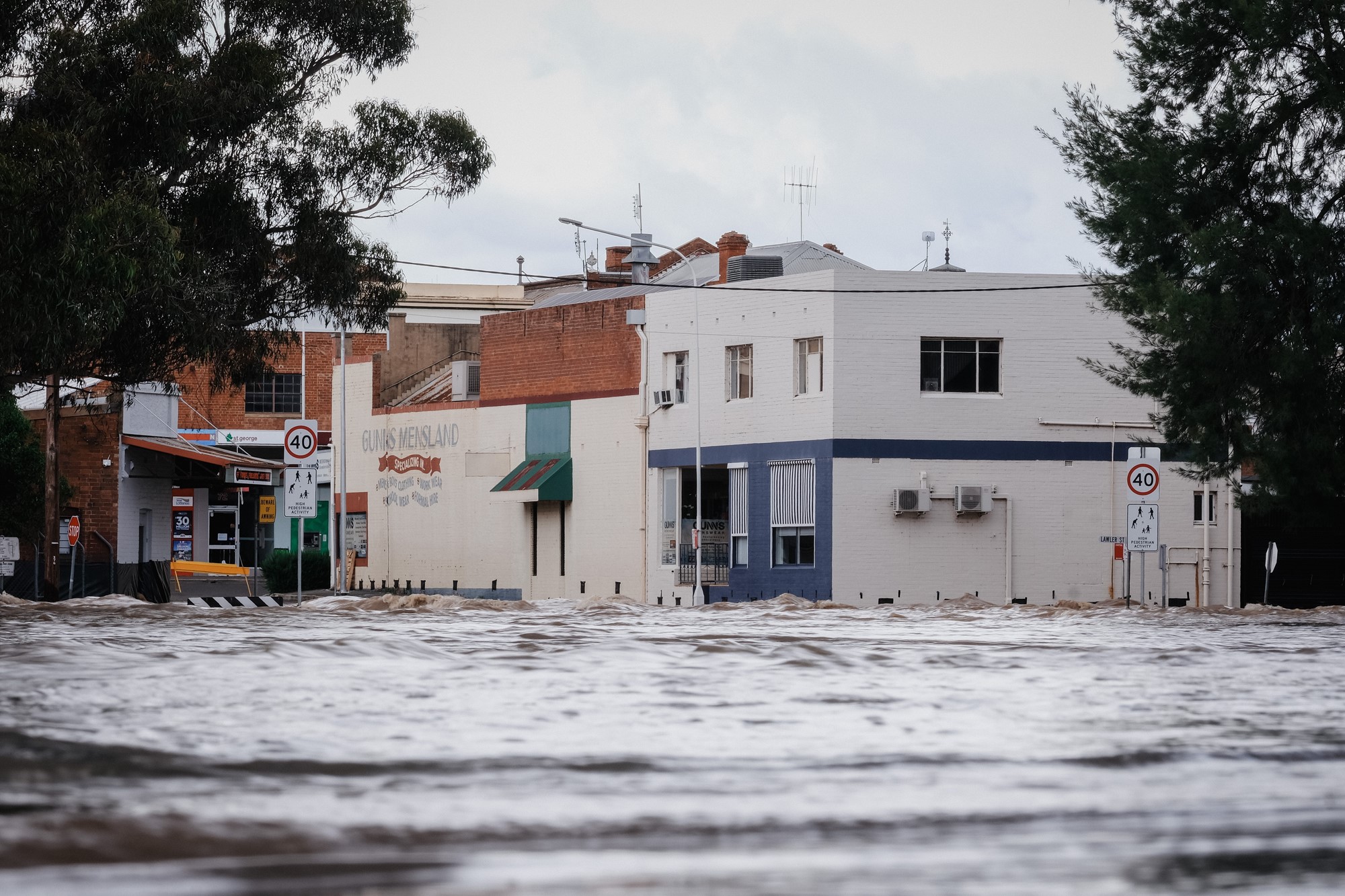 Water levels around the town buildings rushes through the town