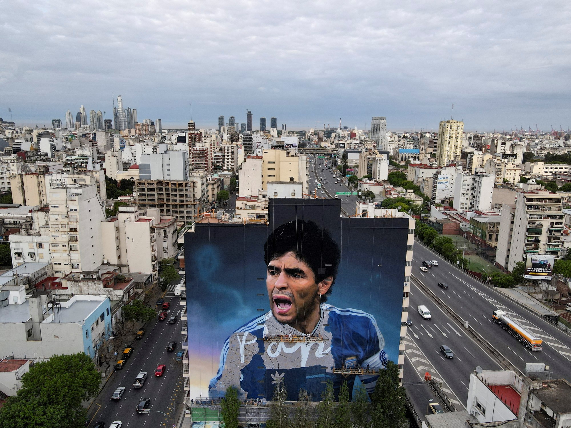 A mural of Diego Maradona on the side of a building.