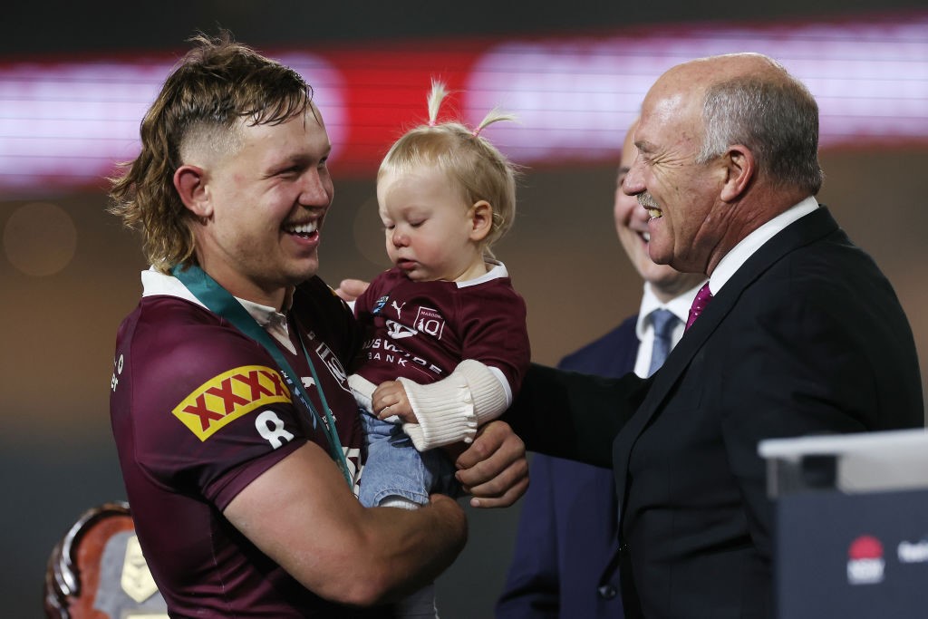 Reuben Cotter with his kid and Wally Lewis.