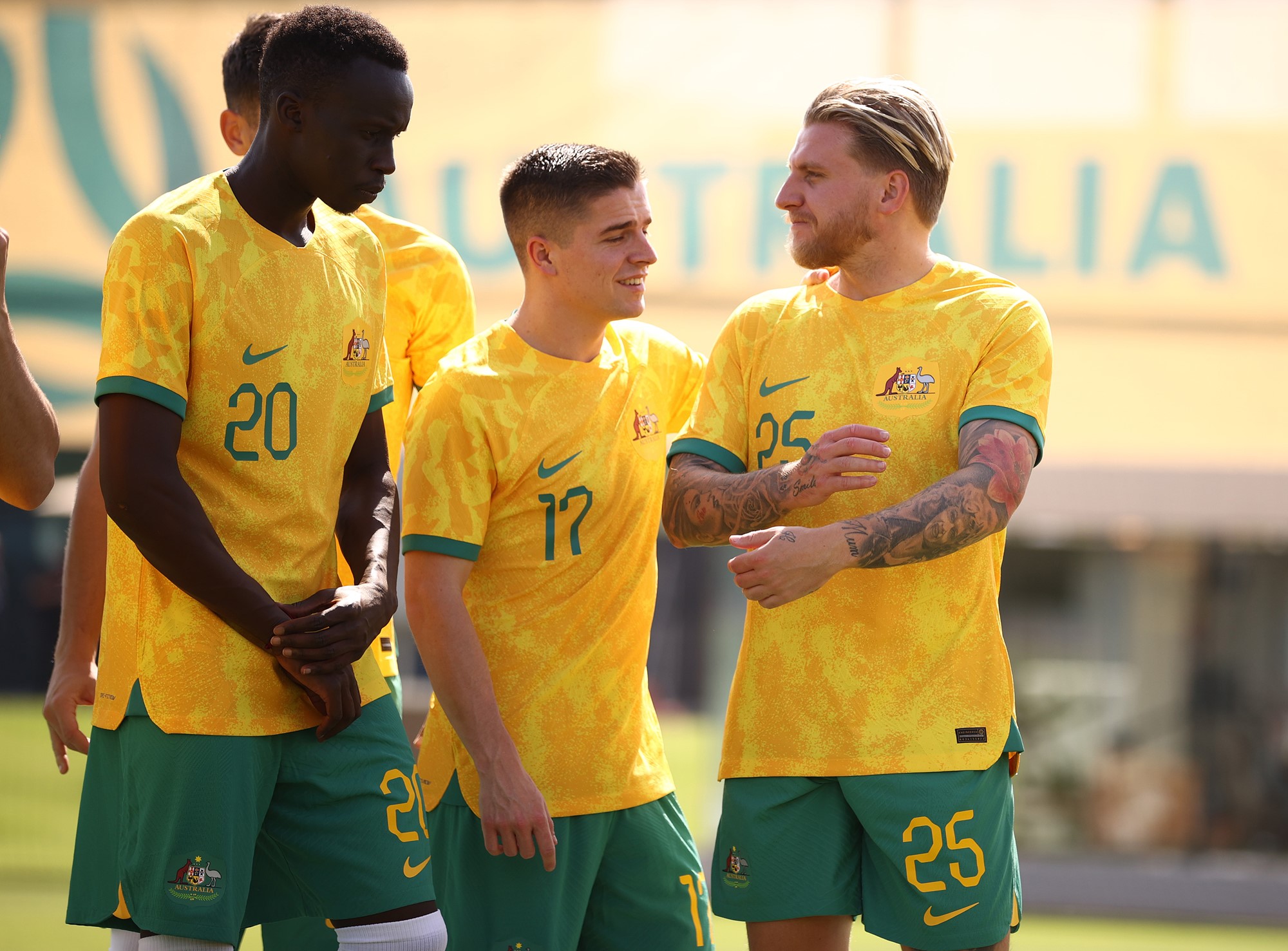Three Socceroos players have a laugh