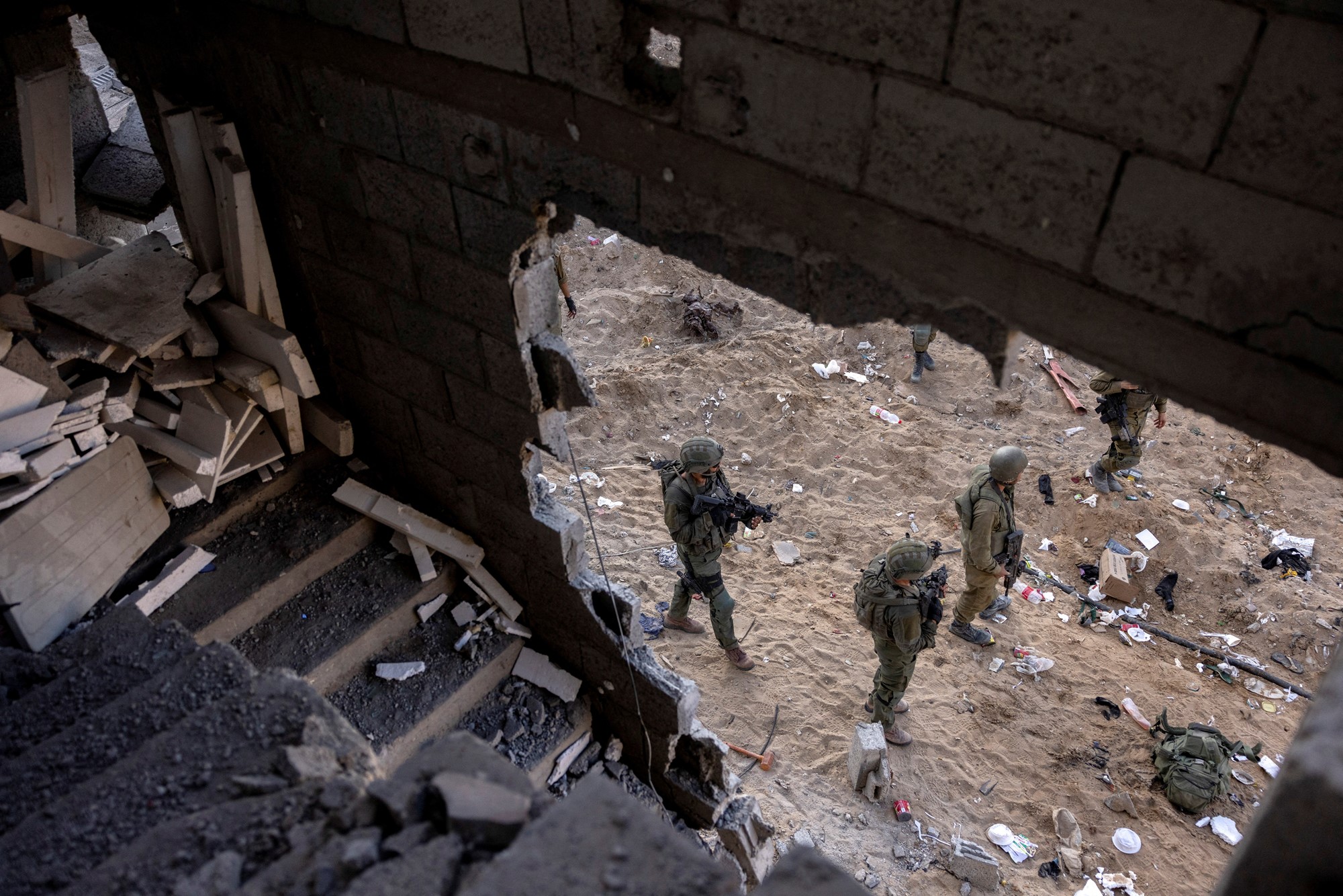 Israeli soldiers walk through rubble of a building in northern Gaza.