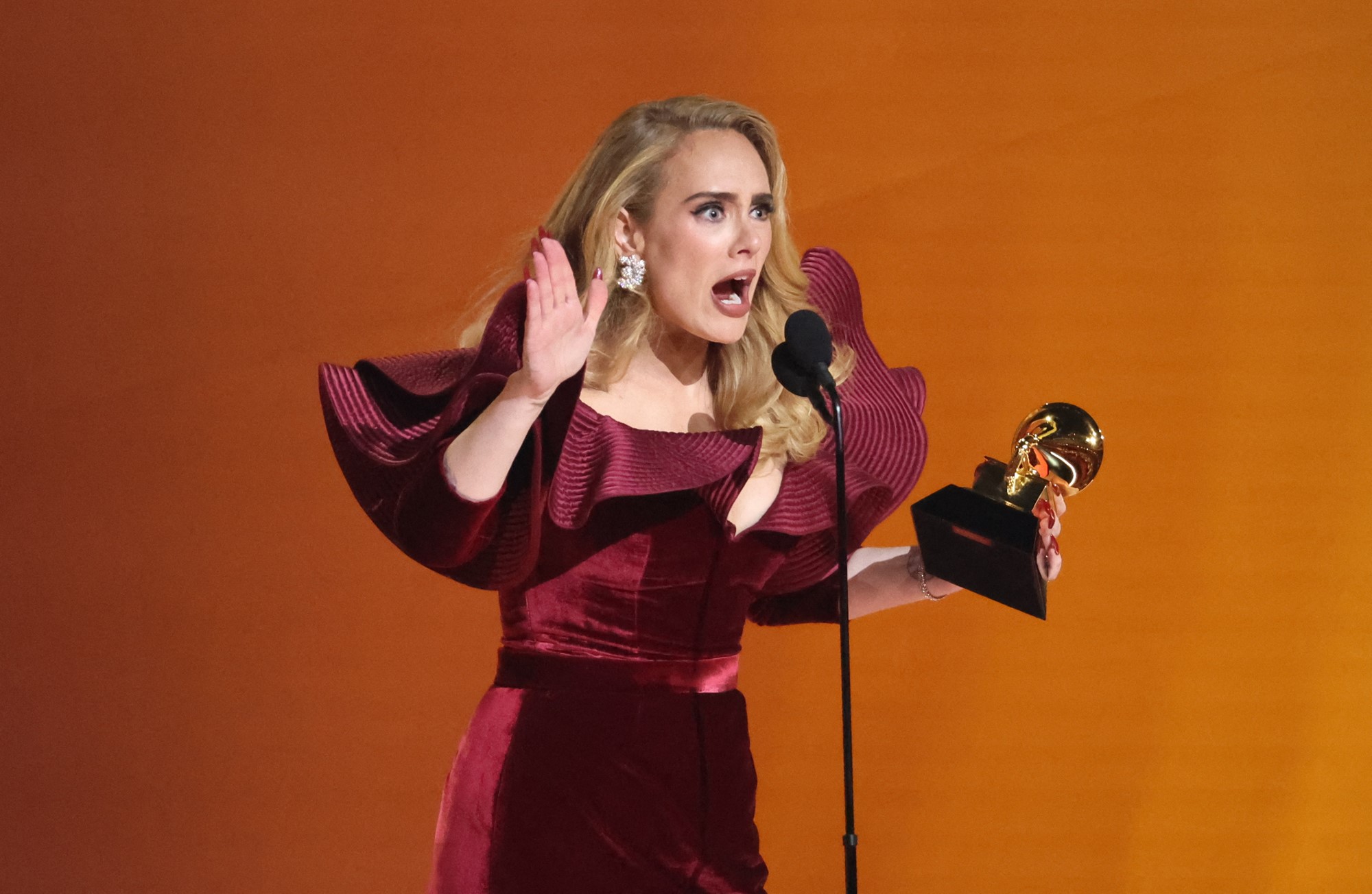 Adele talking into a microphine