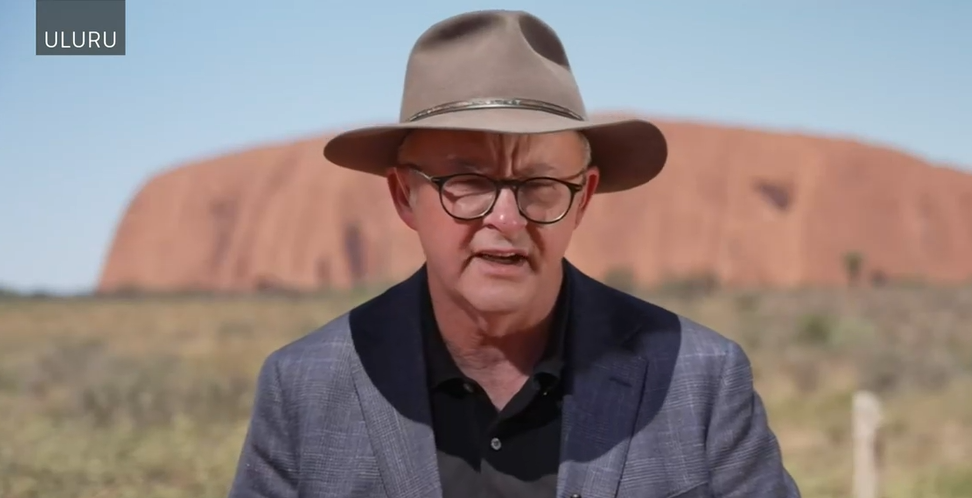 Albanese stands in front of Ayres Rock in Uluru.