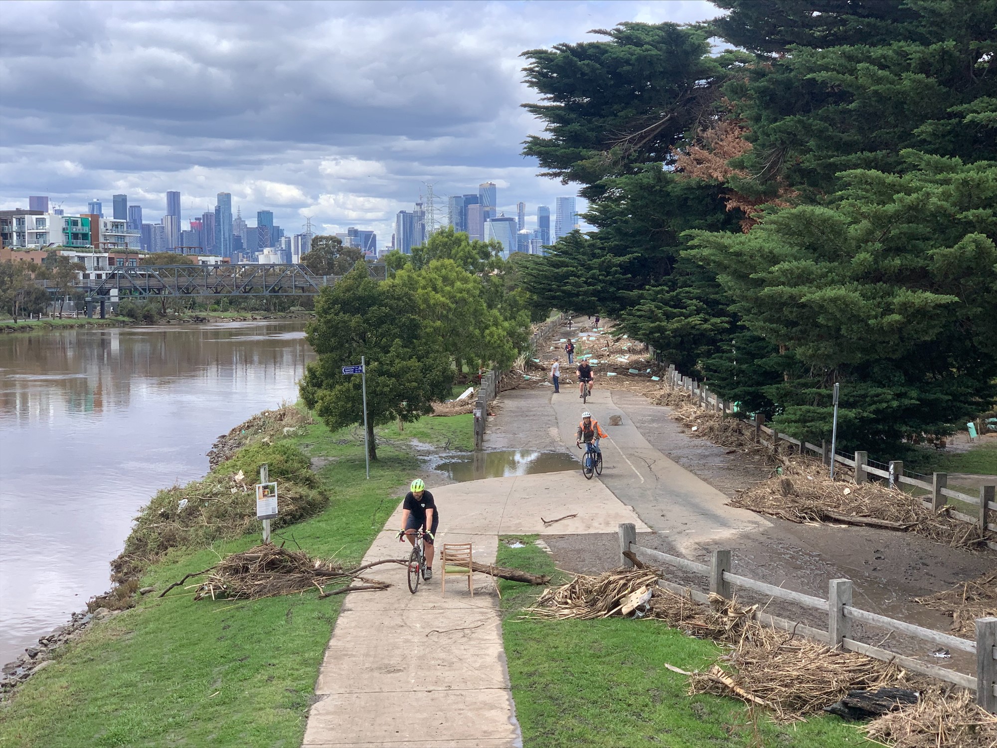 Cyclists move up and down a trail beside Maribyrnong River.