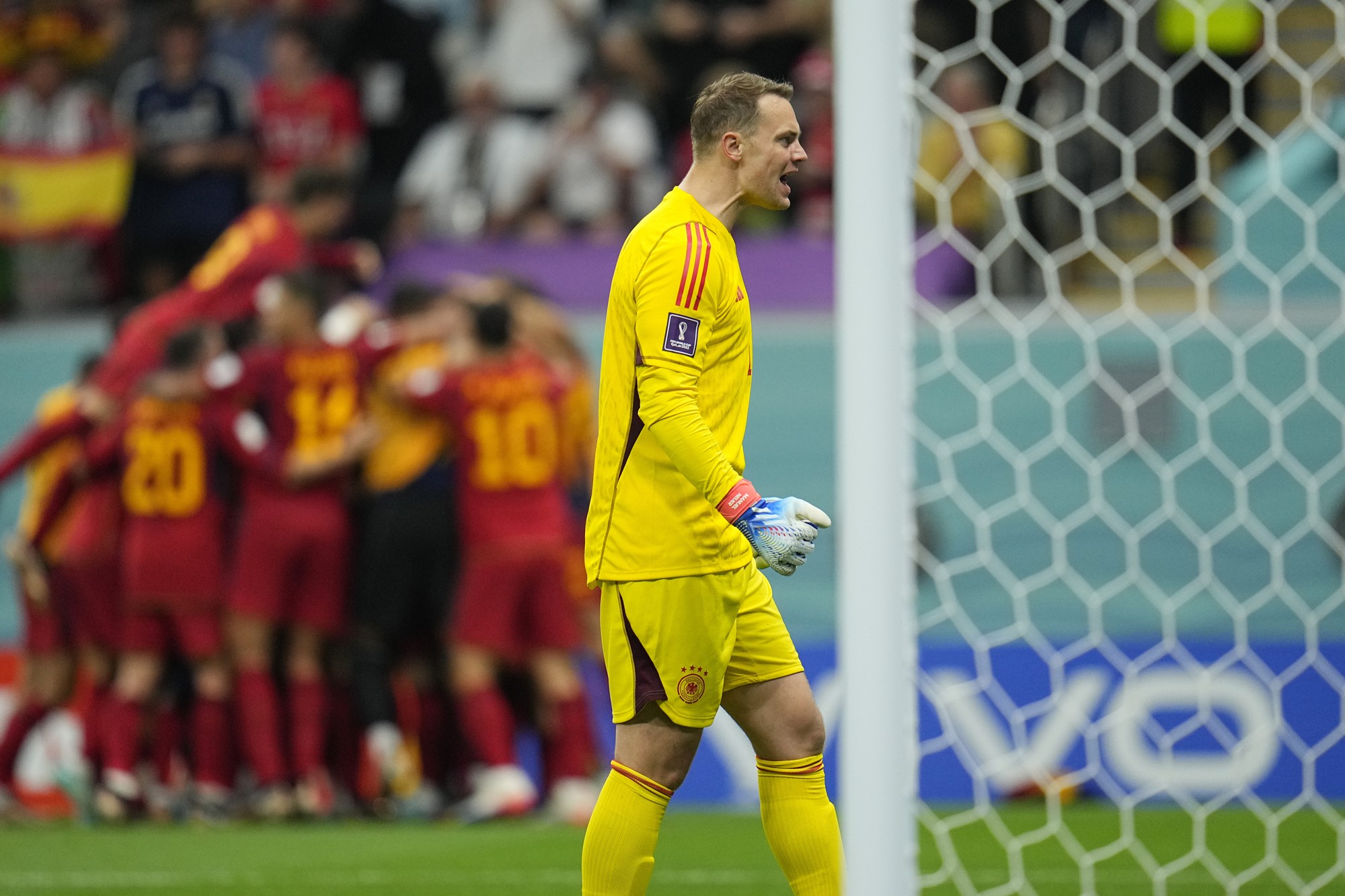 German keeper Manuel Neuer looks dejected as Spain celebrates a goal