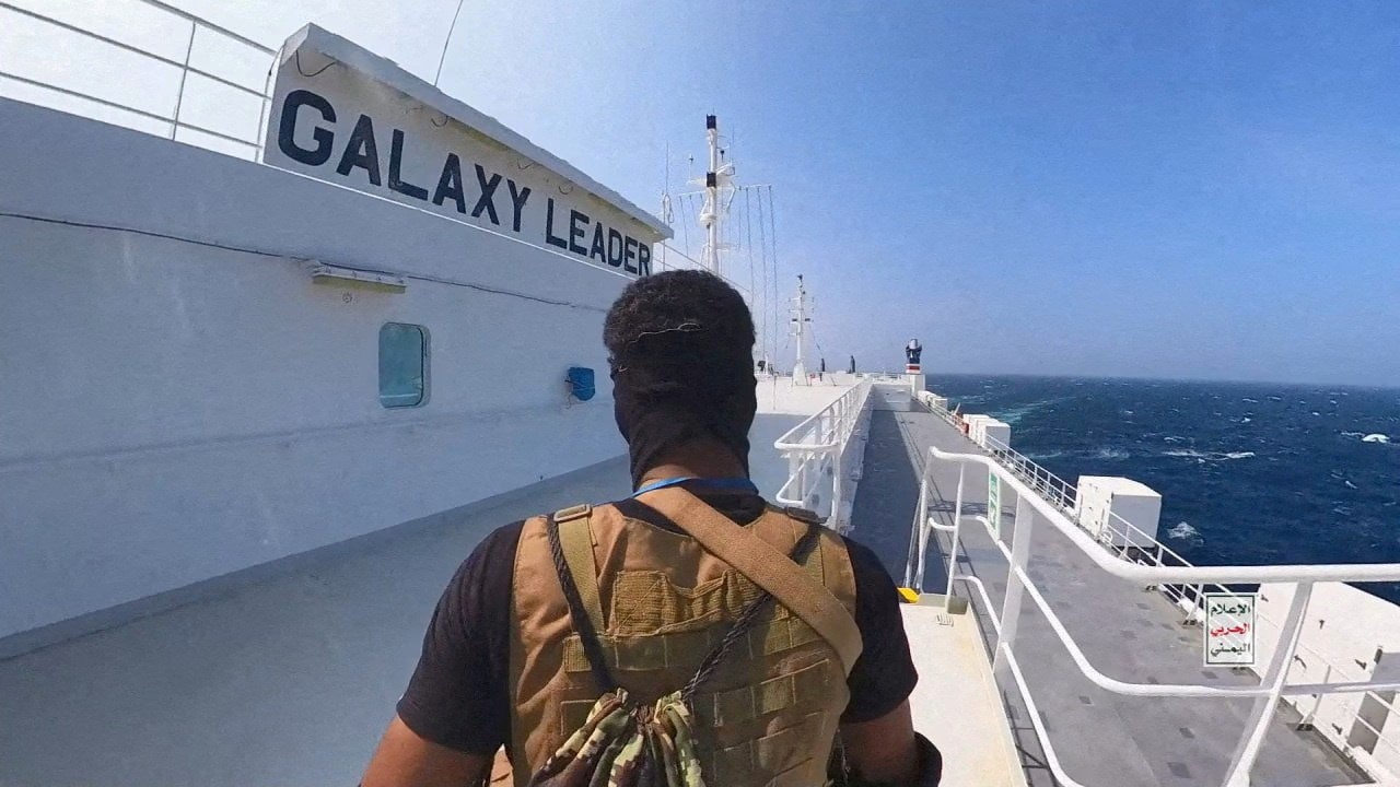 Houthi fighter stands on the Galaxy Leader cargo ship in the Red Sea.
