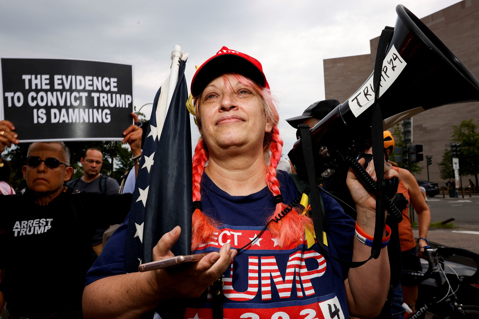 A Trump supporter plays static noise over a bullhorn in front the U.S. District Court in Washington, U.S., August 3, 2023. 