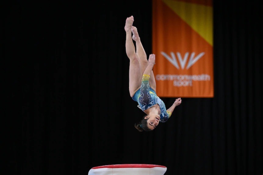 George Godwin flips over a vault during the Commonwealth Games gymnastics.