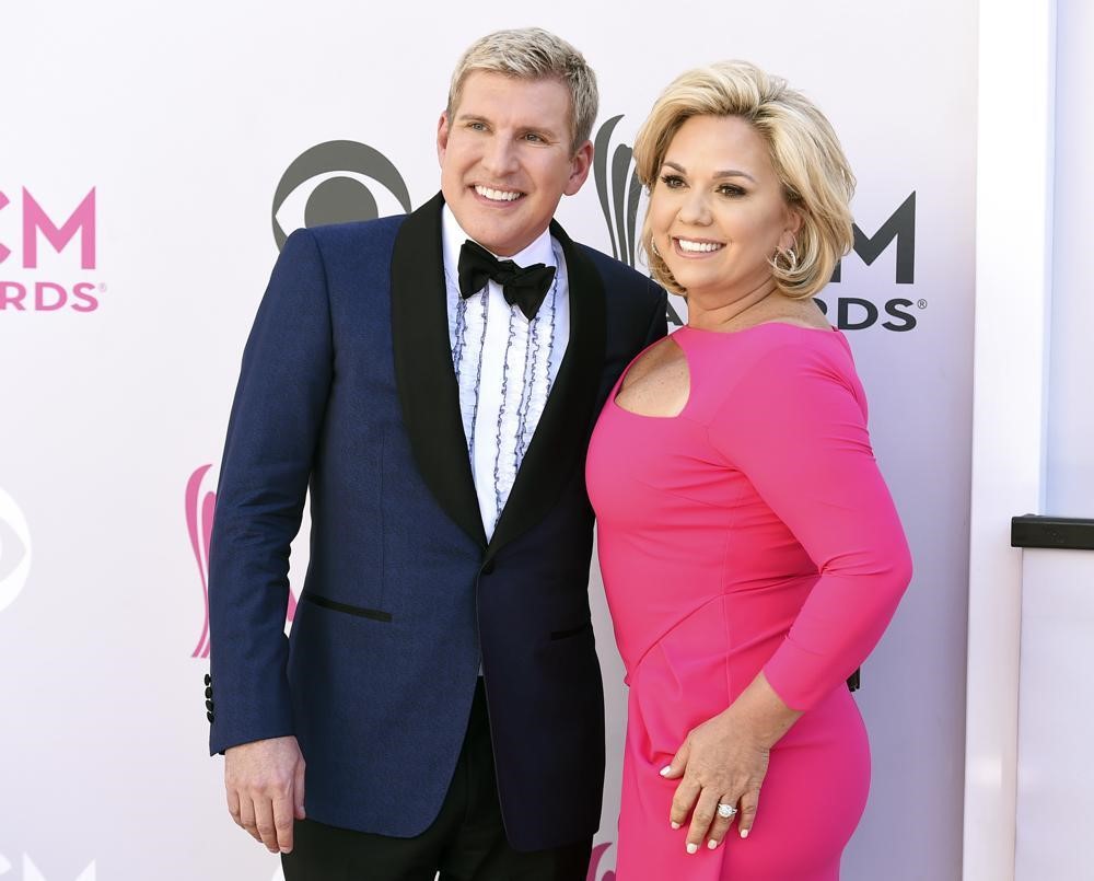 Todd Chrisley, left, and his wife, Julie Chrisley, pose for photos at the 52nd annual Academy of Country Music Awards on April 2, 2017