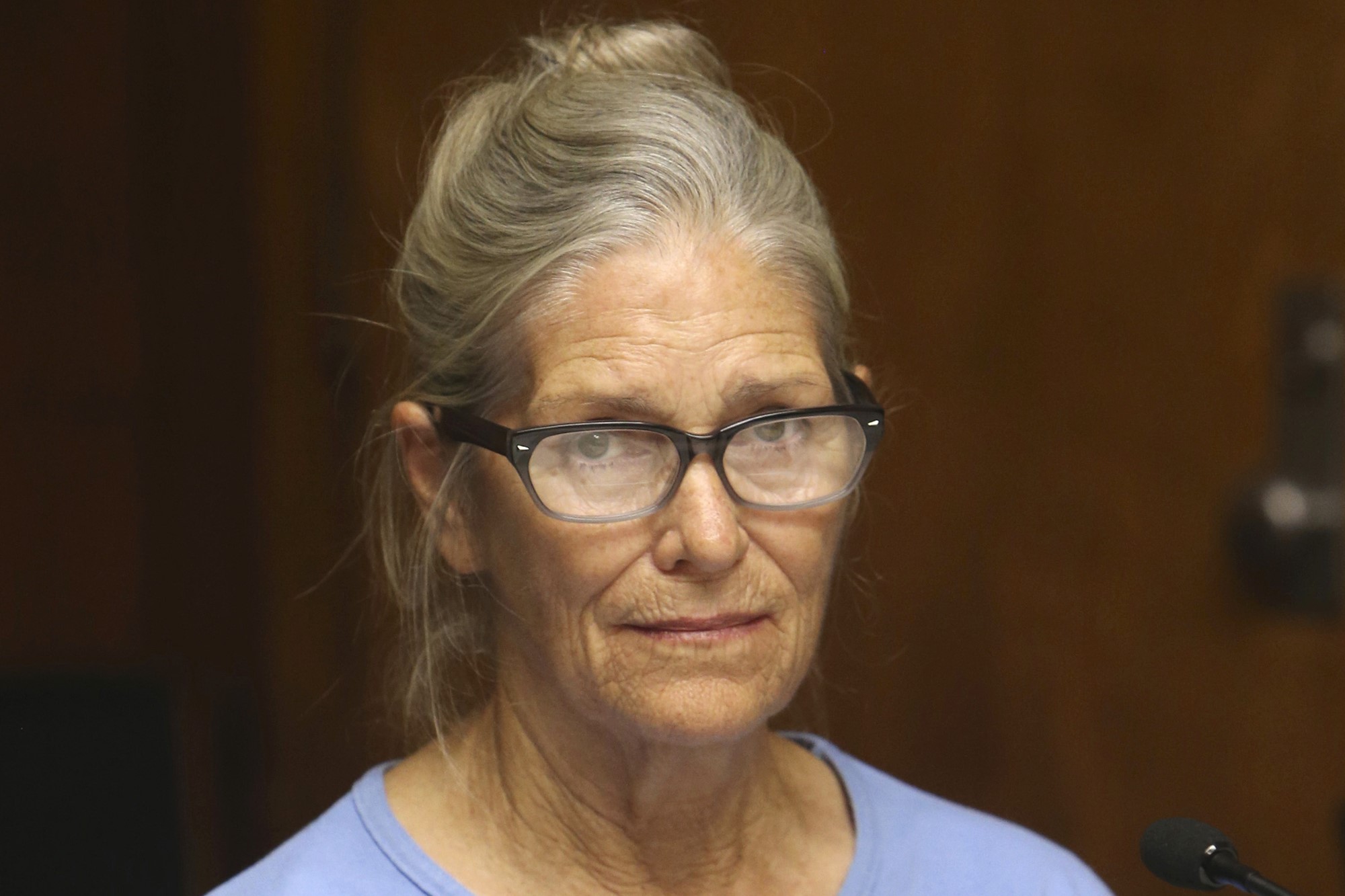 A close up of a middle-aged white woman wearing glasses