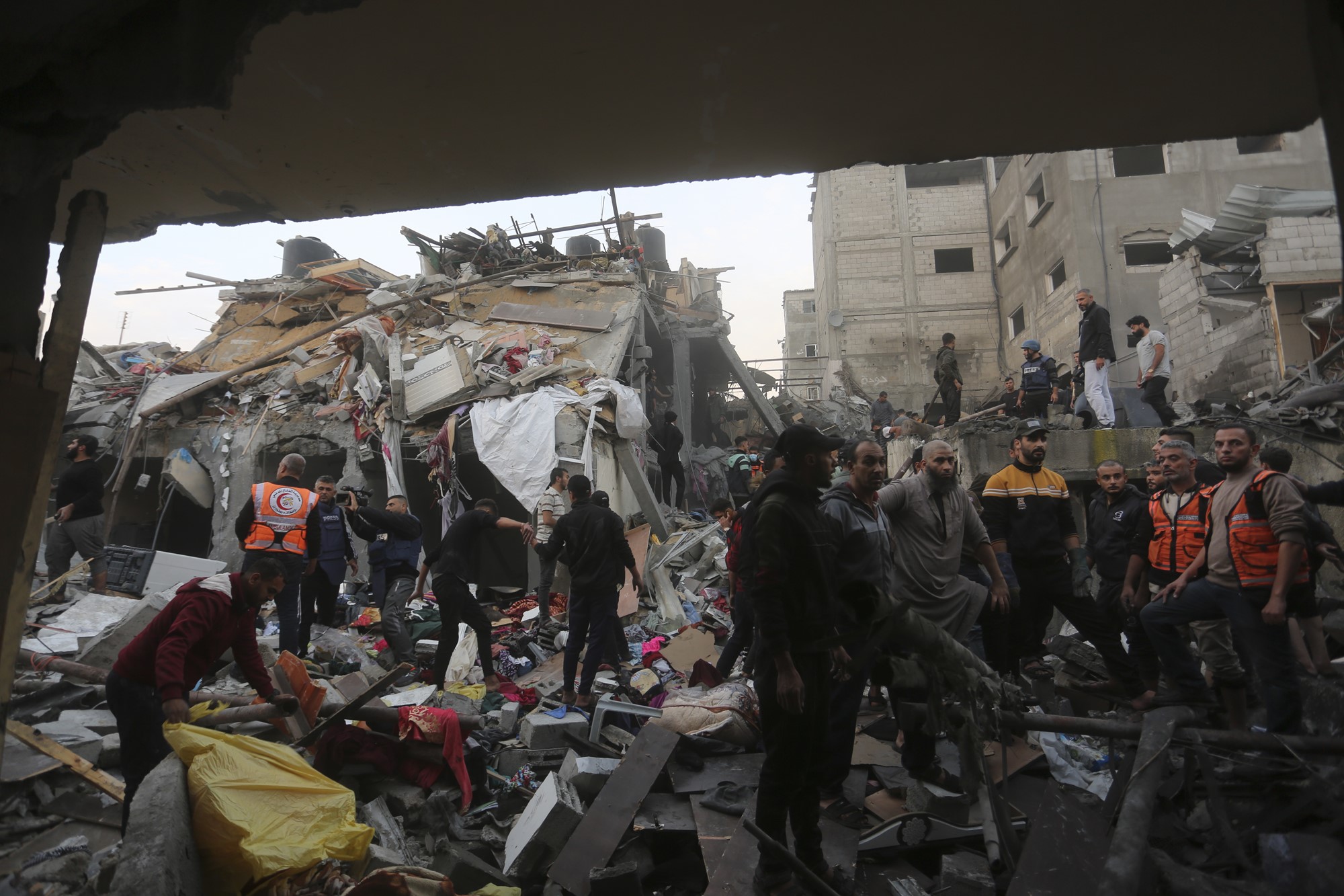 A group of people standing among debris. 