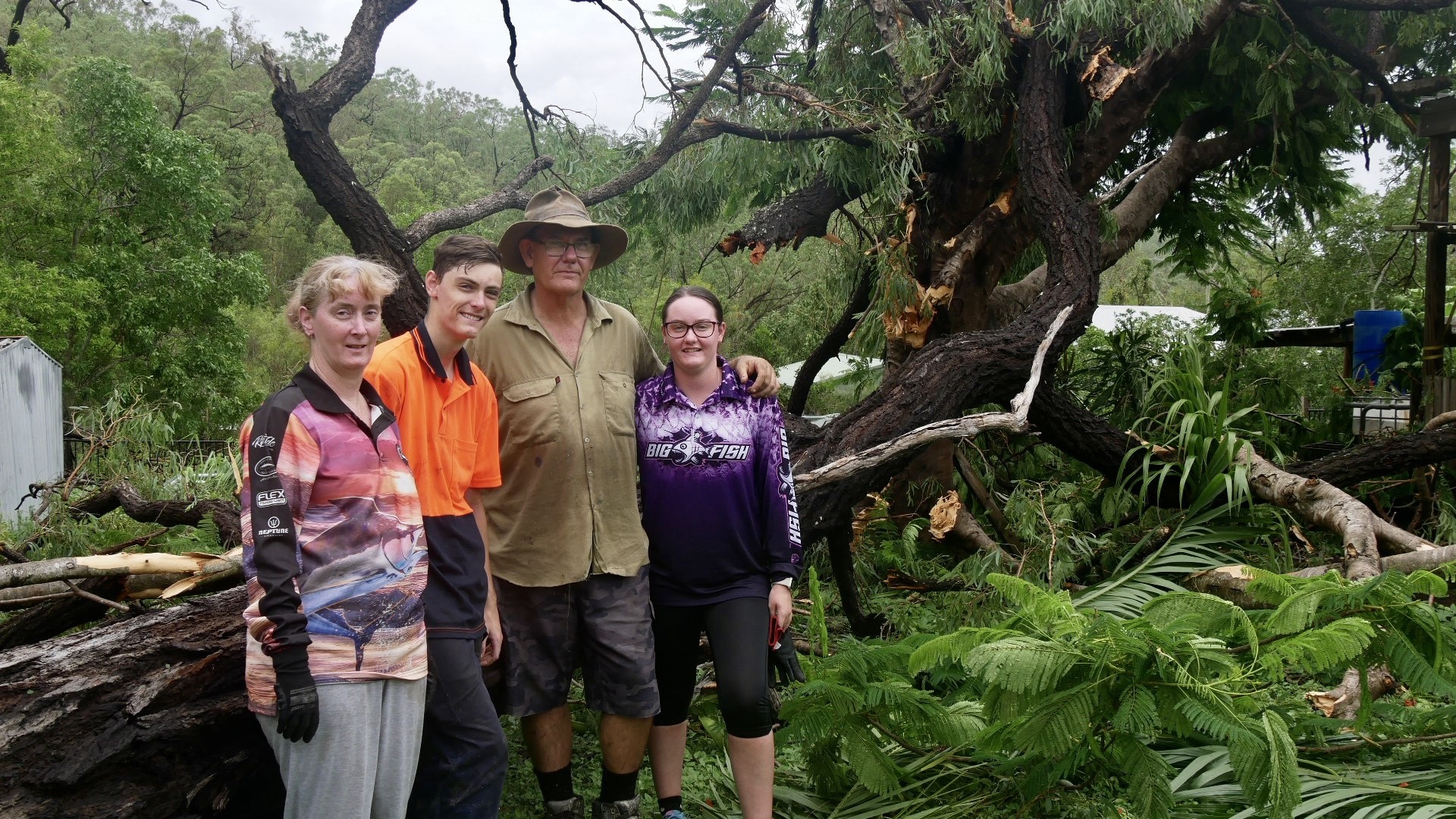 a family standing near a toppled tree