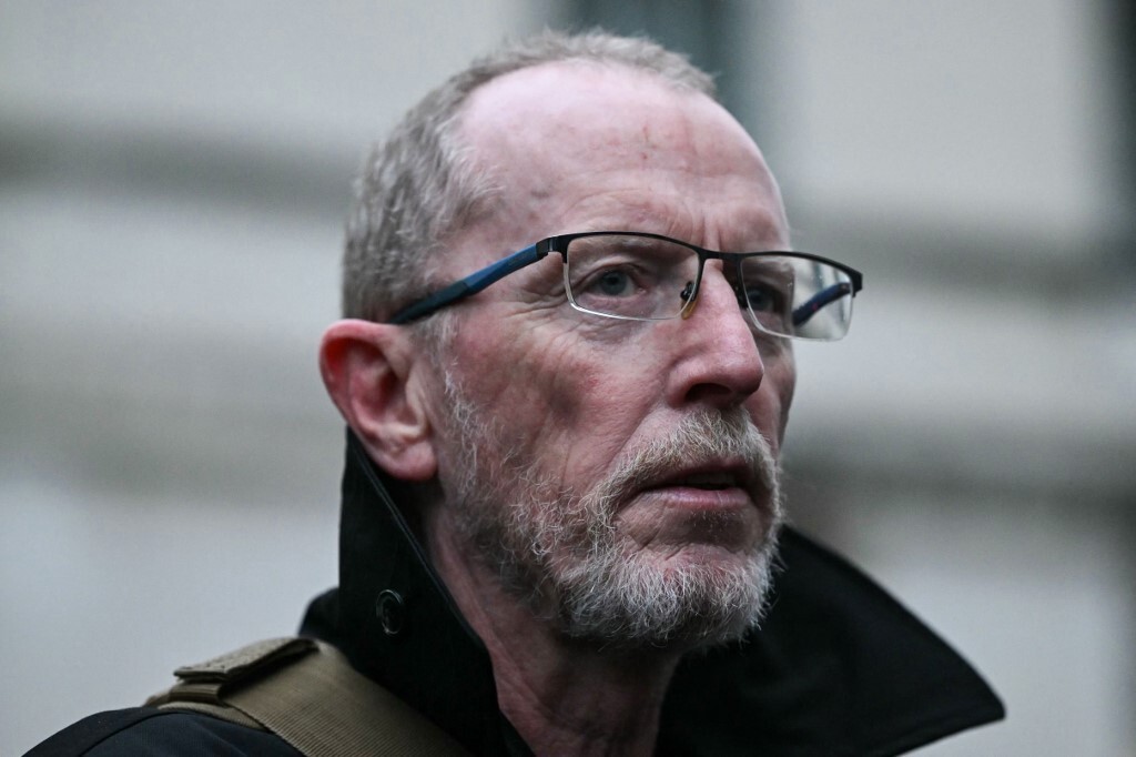 Close up of concerned-looking man with glasses and beard