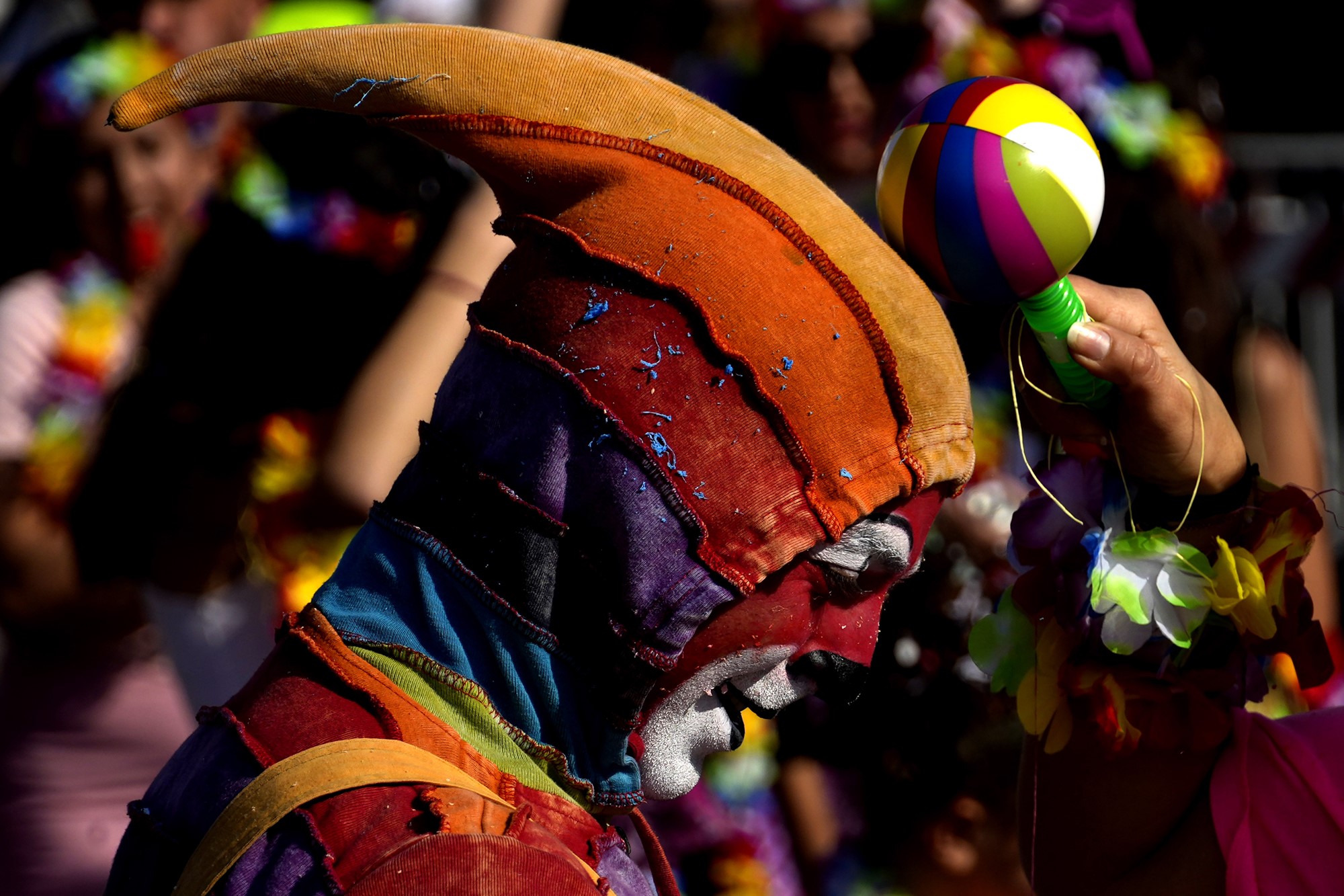 A man wearing carnival costume takes part in a traditional carnival parade