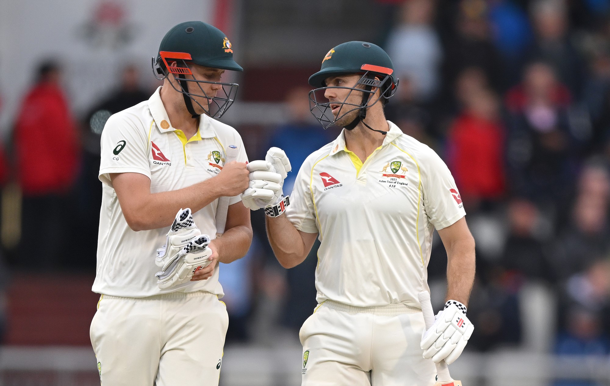 Cameron Green and Mitch Marsh bump fists.