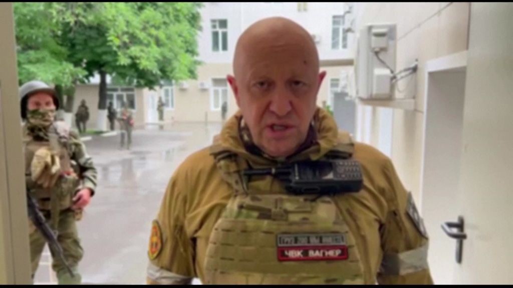 Yevgeny Prigozhin stands in front of a camera, head to toe in military gear