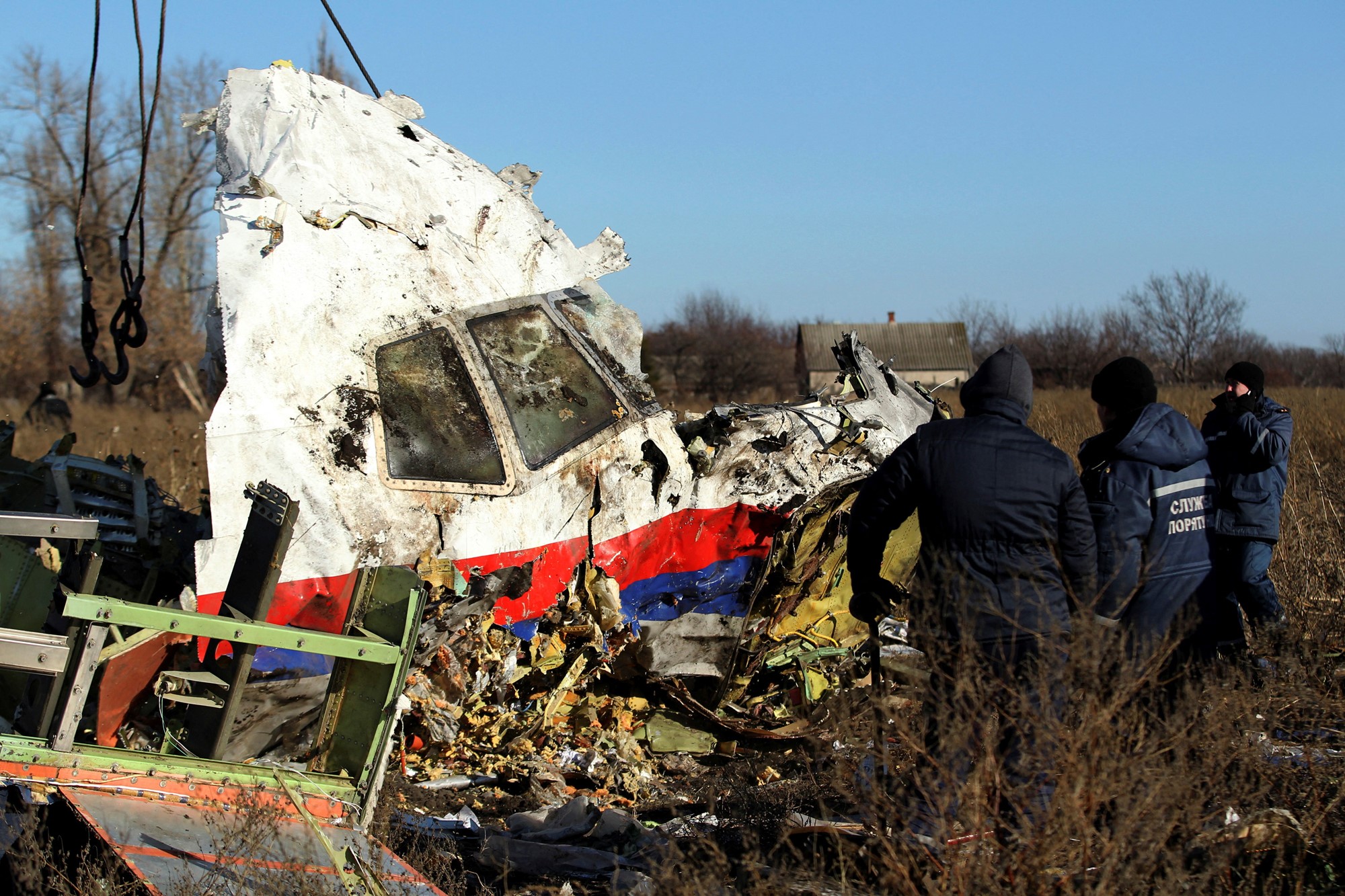 Workers transport a piece of wreckage from MH17 in November 2014.