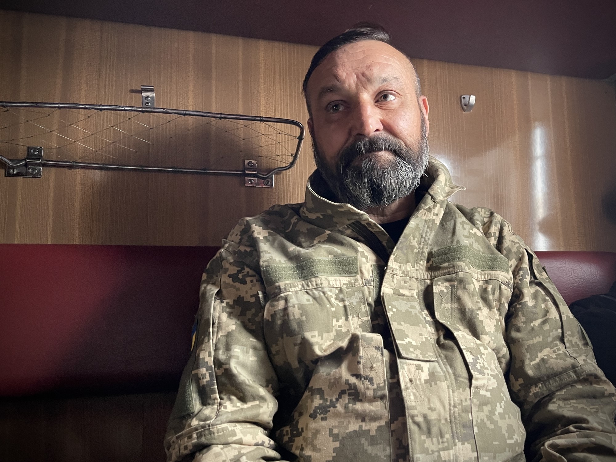 Sergei sits in his military uniform.