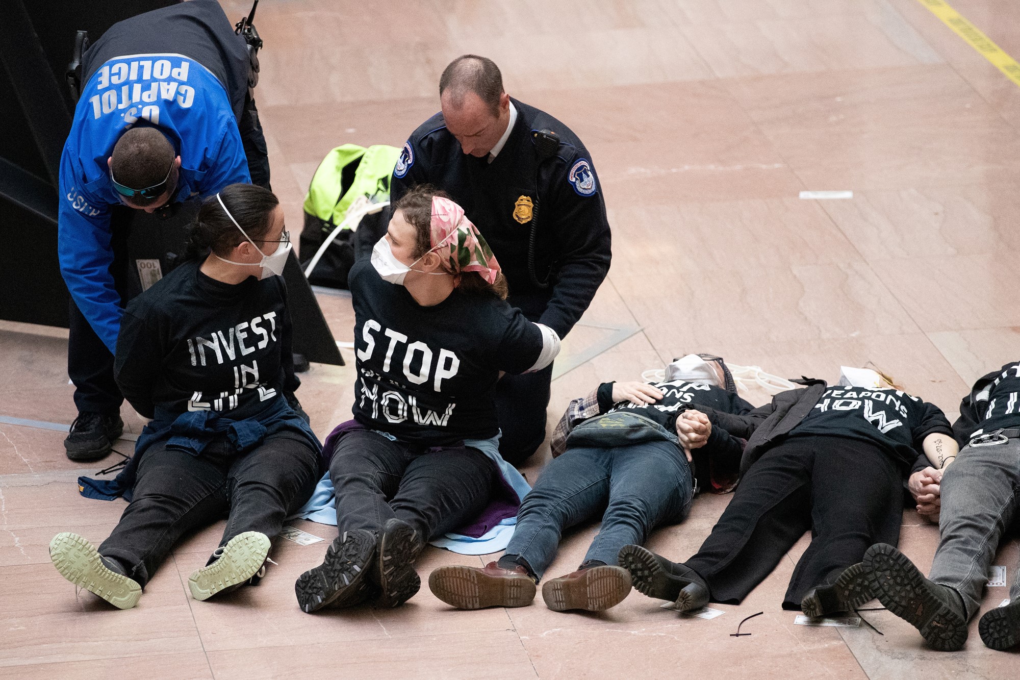 Protesters lie flat on the ground as police start to arrest some of them