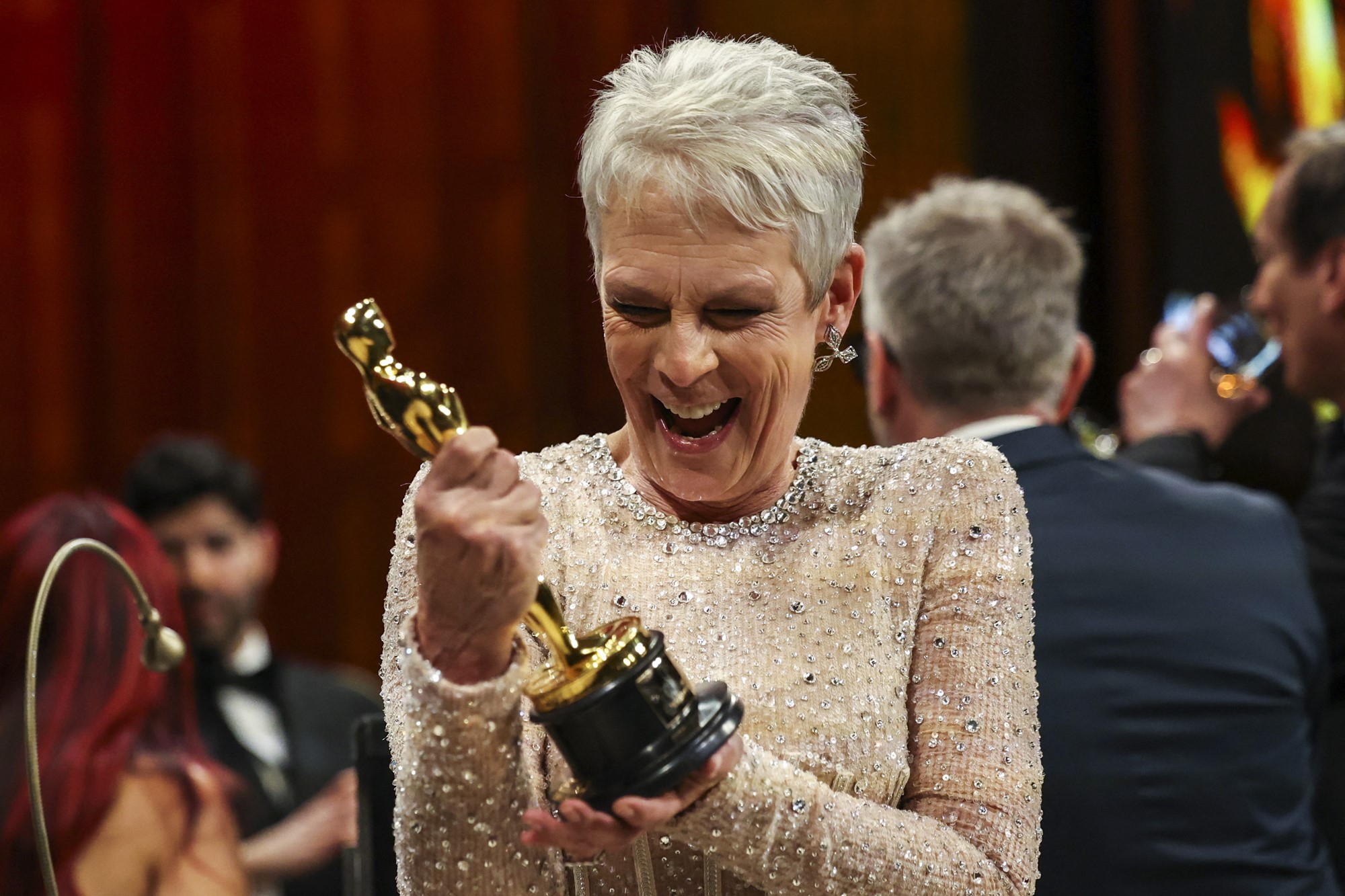 Jamie Lee smiles at her trophy.