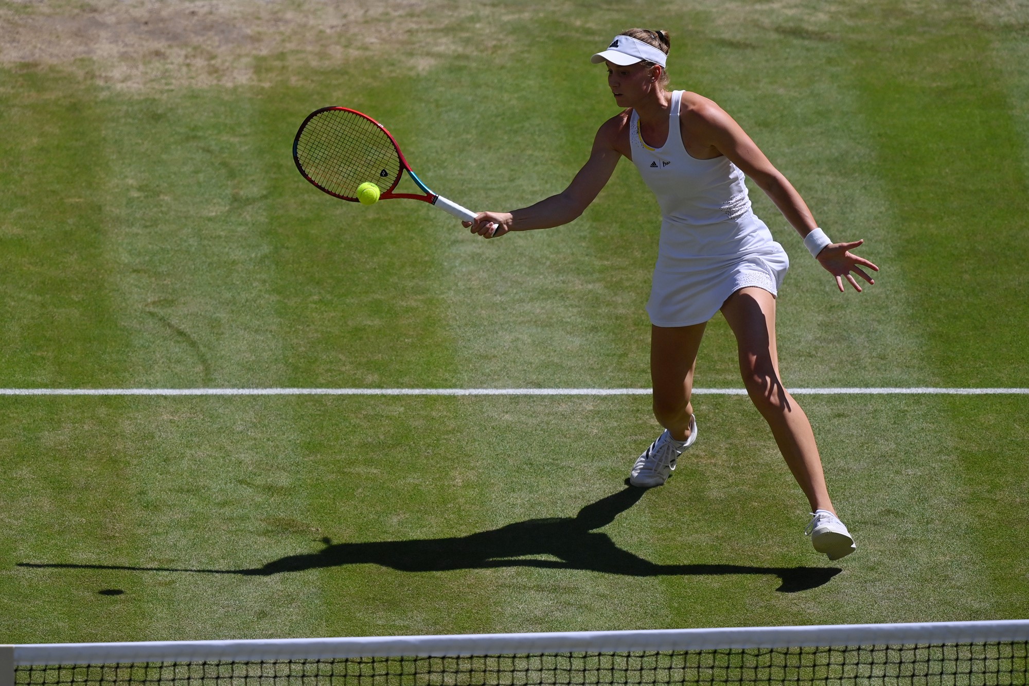 Elena Rybakina plays a forehand volley in the Wimbledon final.