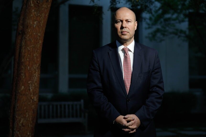 Frydenberg posts for a portrait in the courtyard of Parliament in the evening.